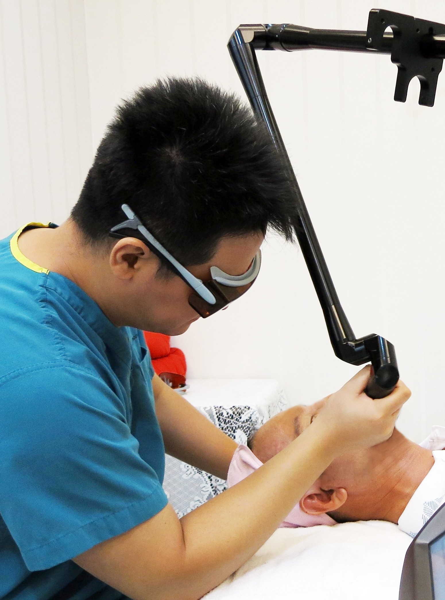 A client undergoing cosmetic laser treatment for a client. Photo: Ben Chang