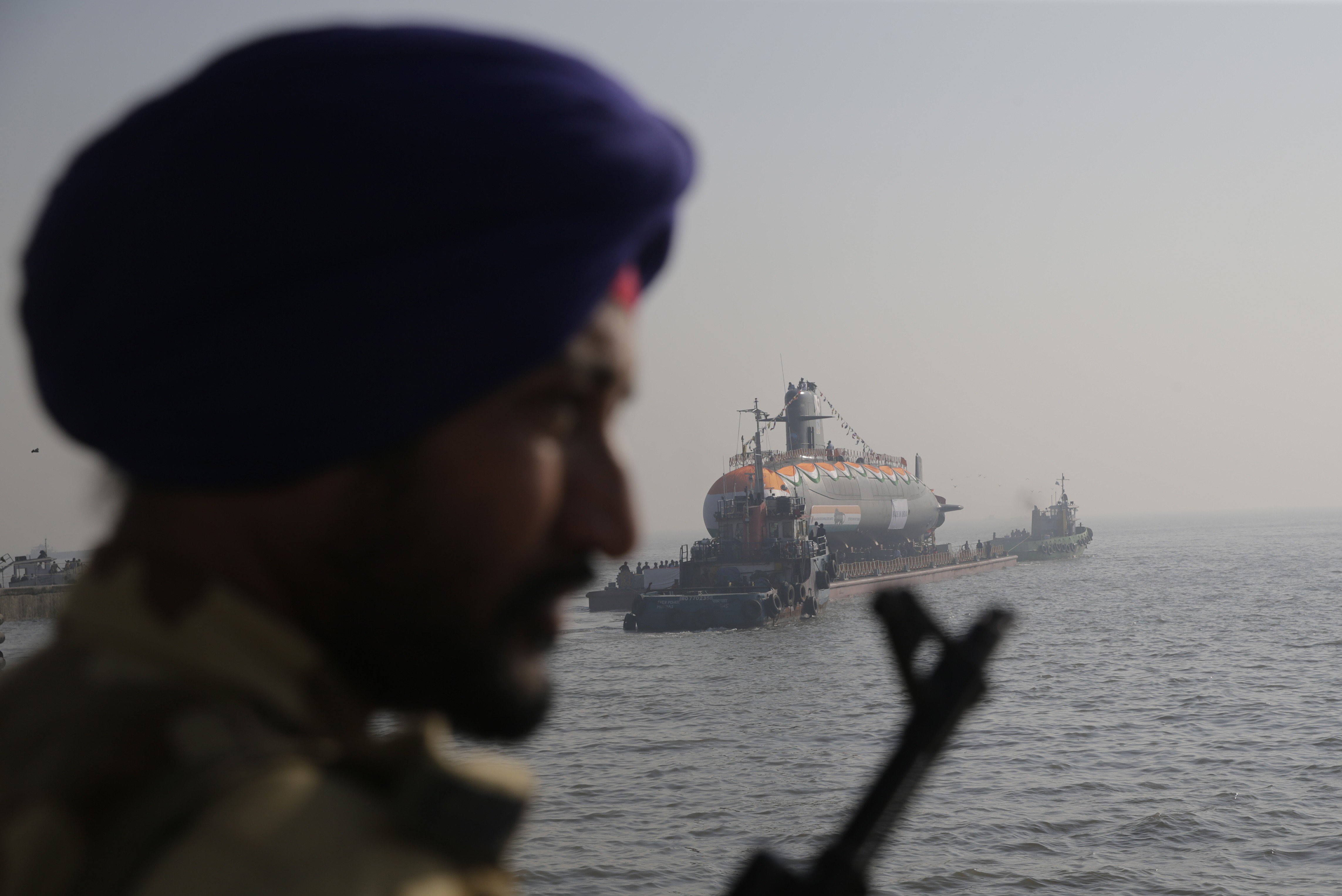 A guard looks on as the Karanj, India's third Scorpene class submarine, is set afloat during its launch at the Mazagon Dock Shipbuilders, in Mumbai on January 31. Photo: AP