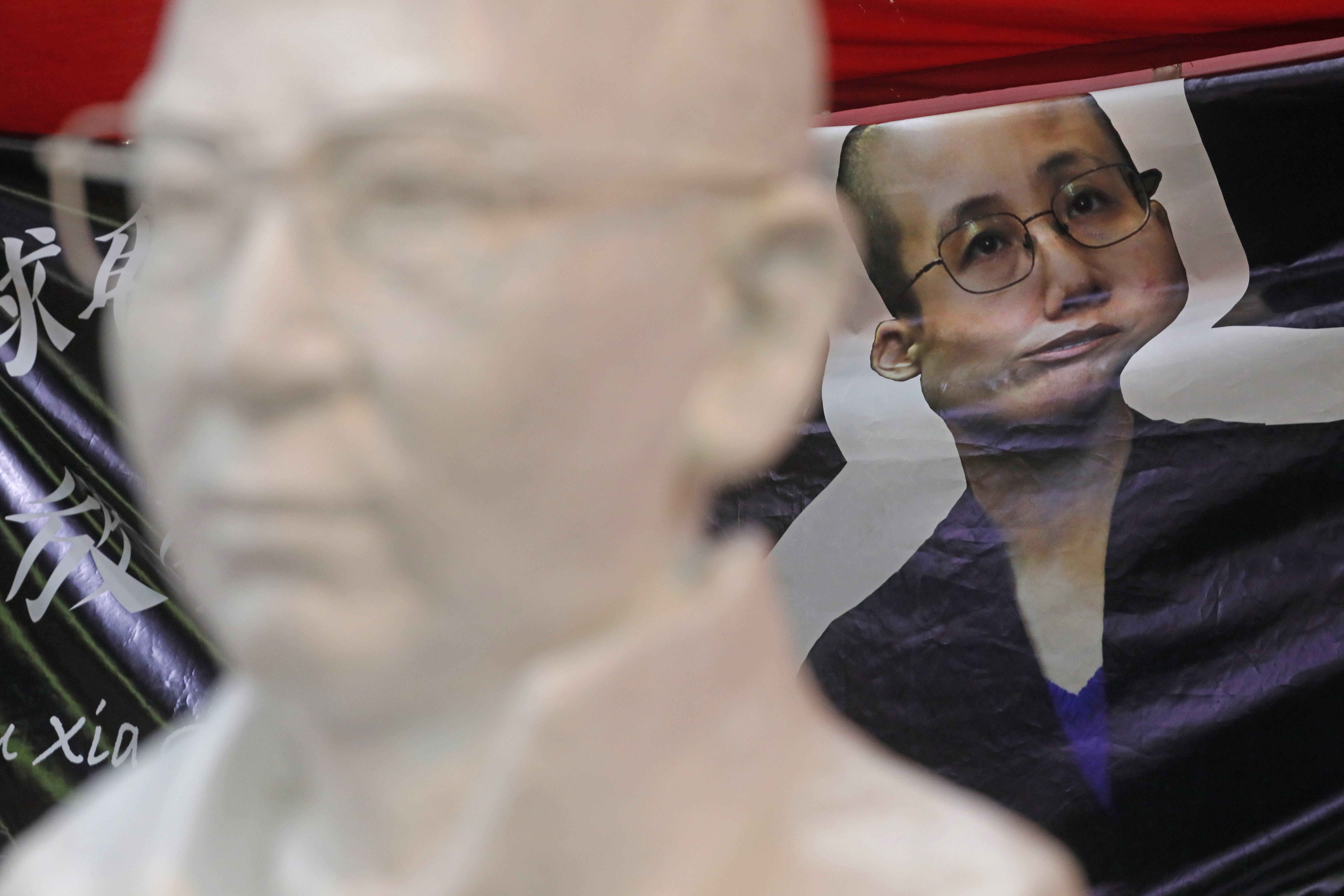 A statue of late Nobel laureate Liu Xiaobo and a picture of his wife Liu Xia on display in Hong Kong. Photo: AP