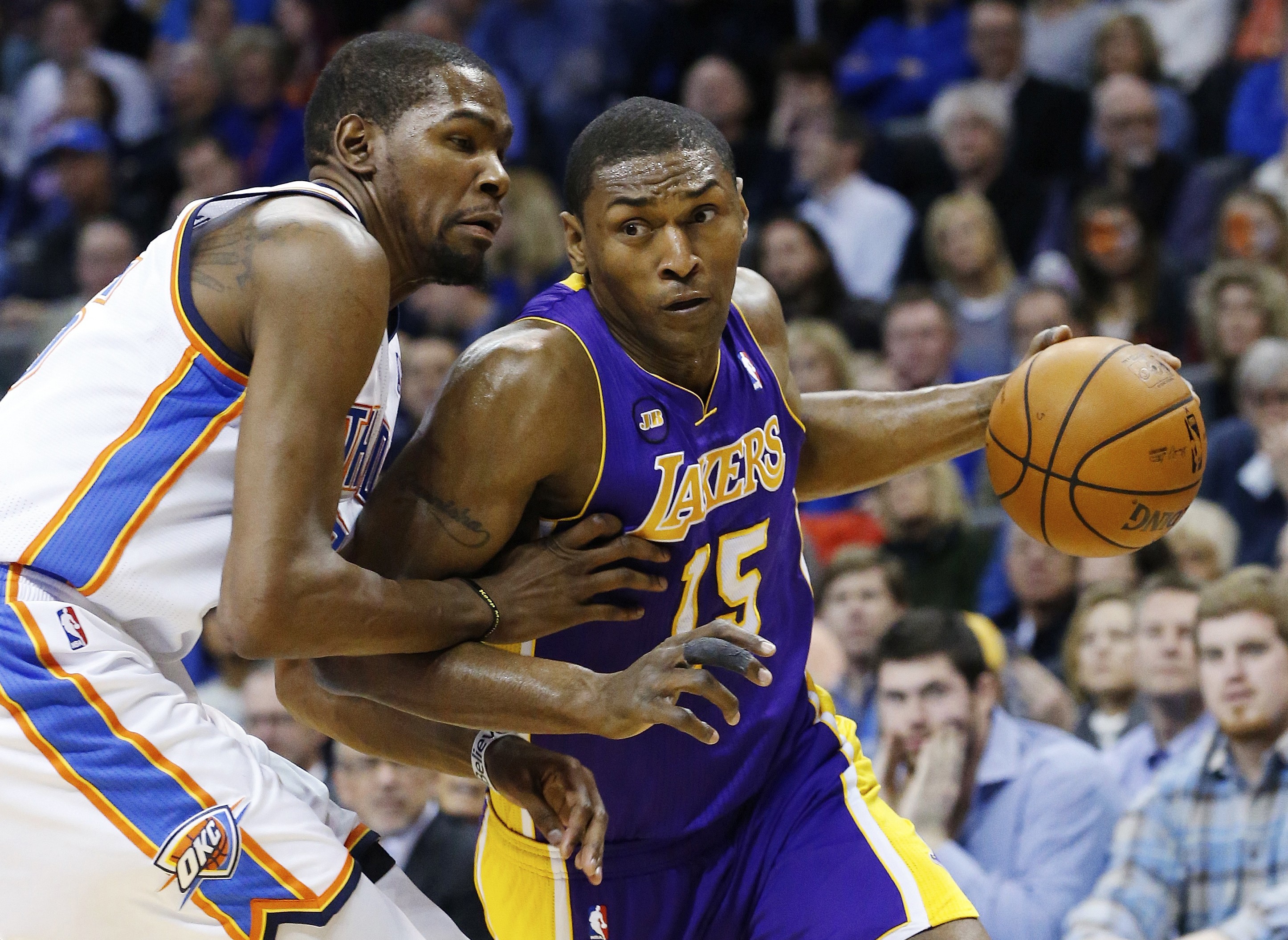 Los Angeles Lakers forward Metta World Peace (15) drives around Oklahoma City Thunder forward Kevin Durant (35) in the first quarter of an NBA basketball game in Oklahoma City, Tuesday, March 5, 2013. Photo: AP