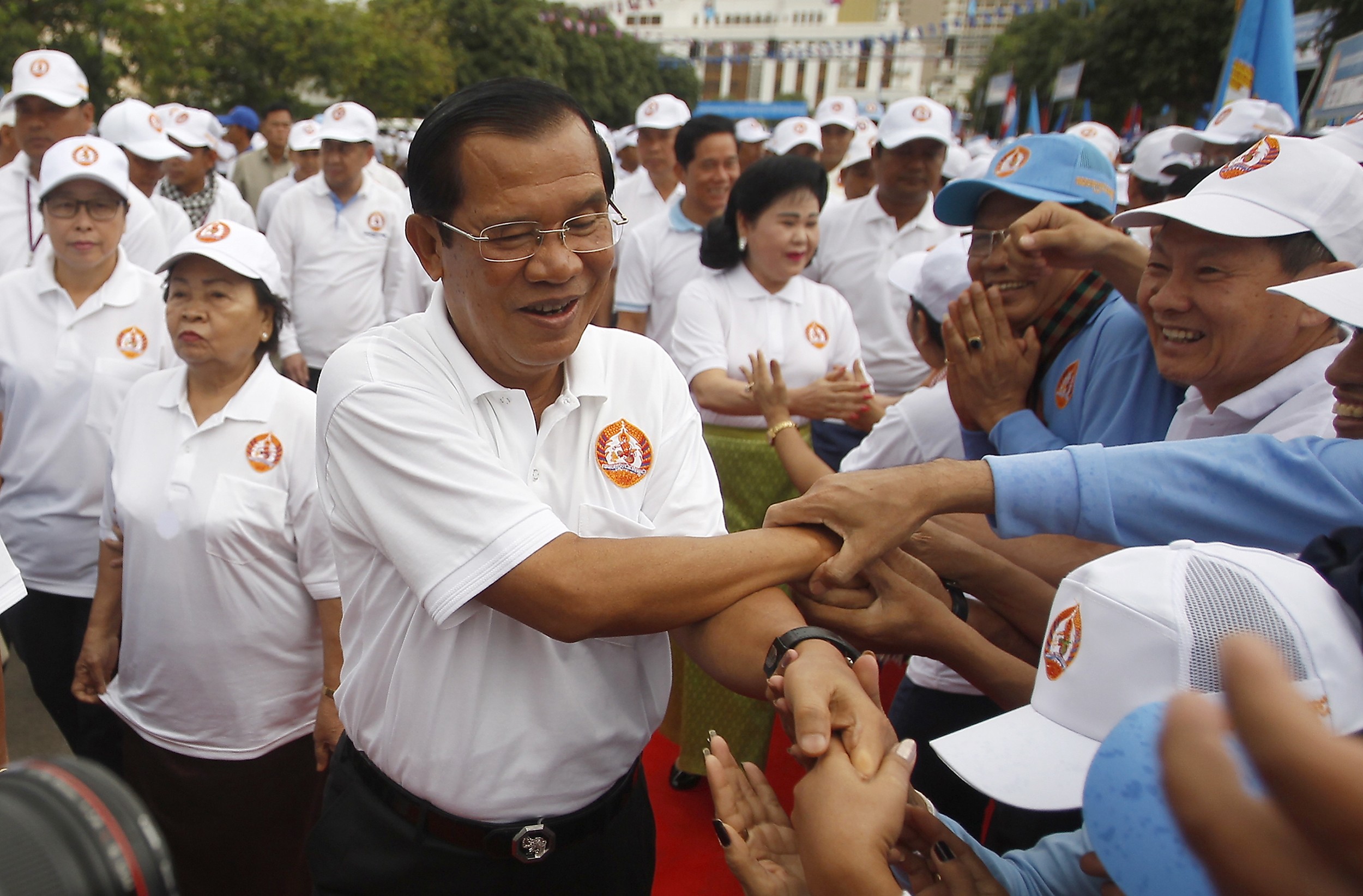 Cambodian Prime Minister Hun Sen greets supporters at a campaign rally on July 7. His Cambodian People’s Party is expected to sweep the polls after the government dissolved the main opposition party. The Cambodian strongman is at the peak of a reign that began in 1985. Photo: AP