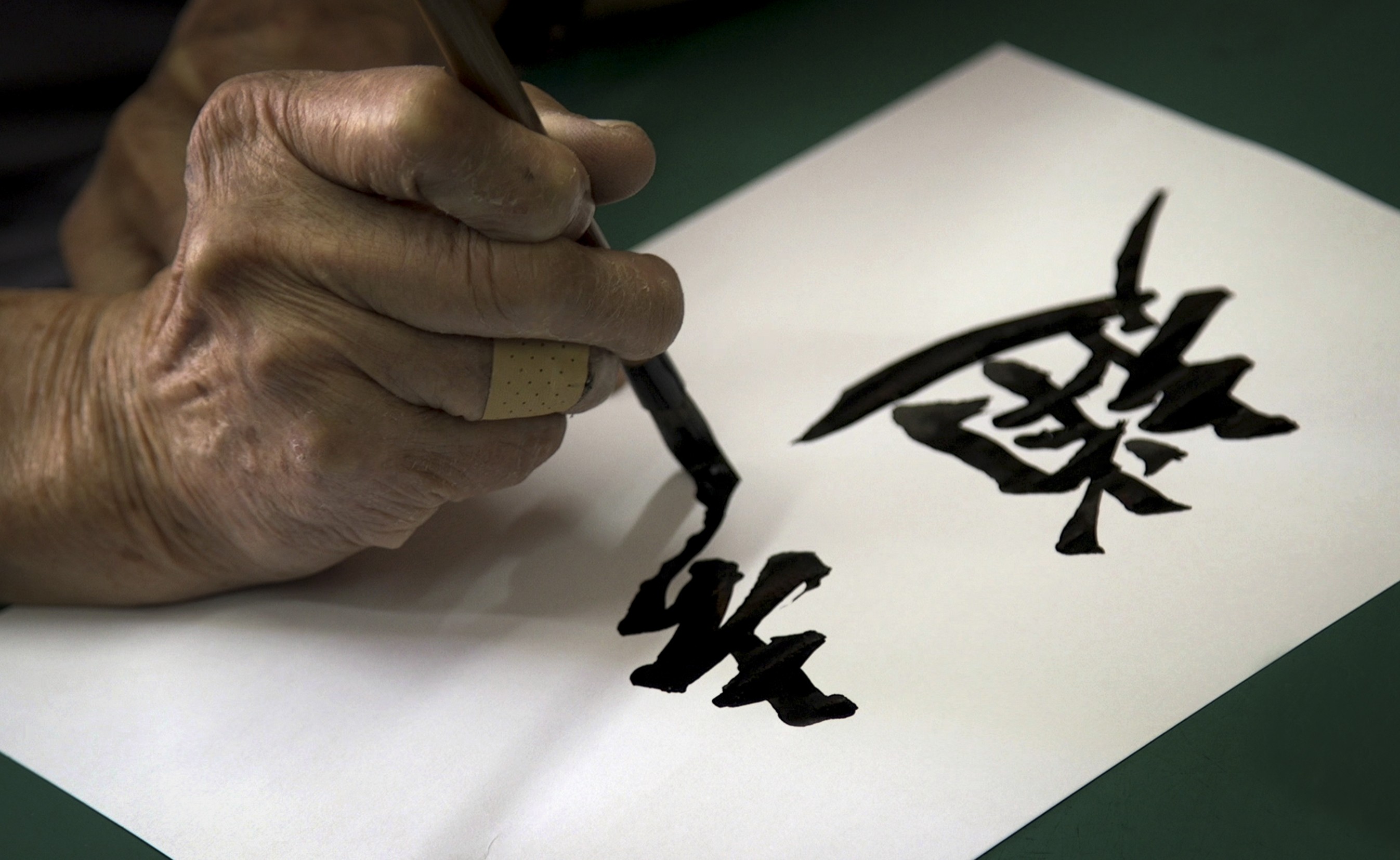 Yeung Kai, 82, has devoted his life to the unique, expressive calligraphy style used on Hong Kong neon lights and shop signs, a trade that is now dying. A graphic designer is digitising the characters for a typeface to give it new life