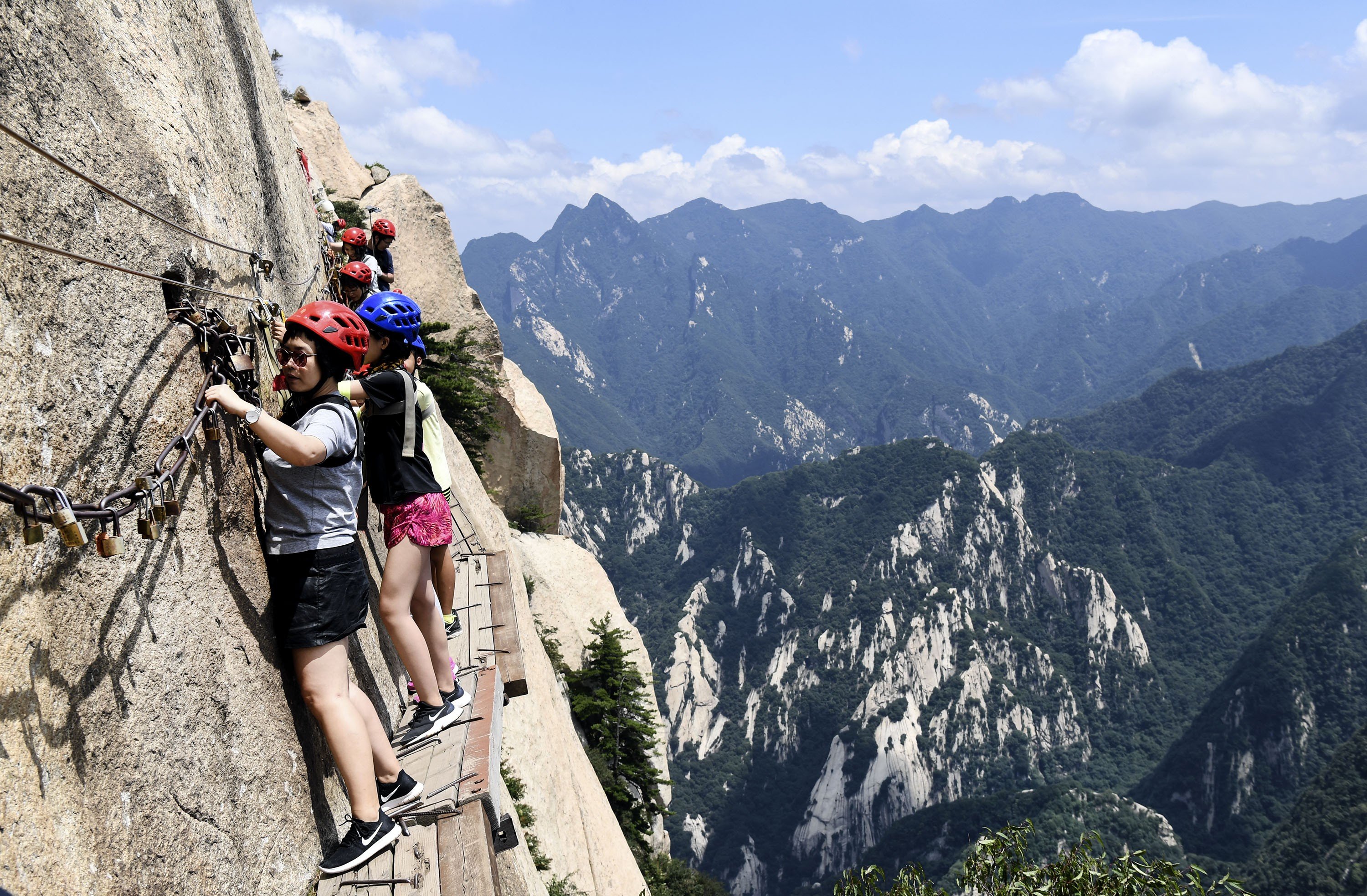 Visitors make their way along the narrow path on Huashan’s southern peak. Photo: Xinhua
