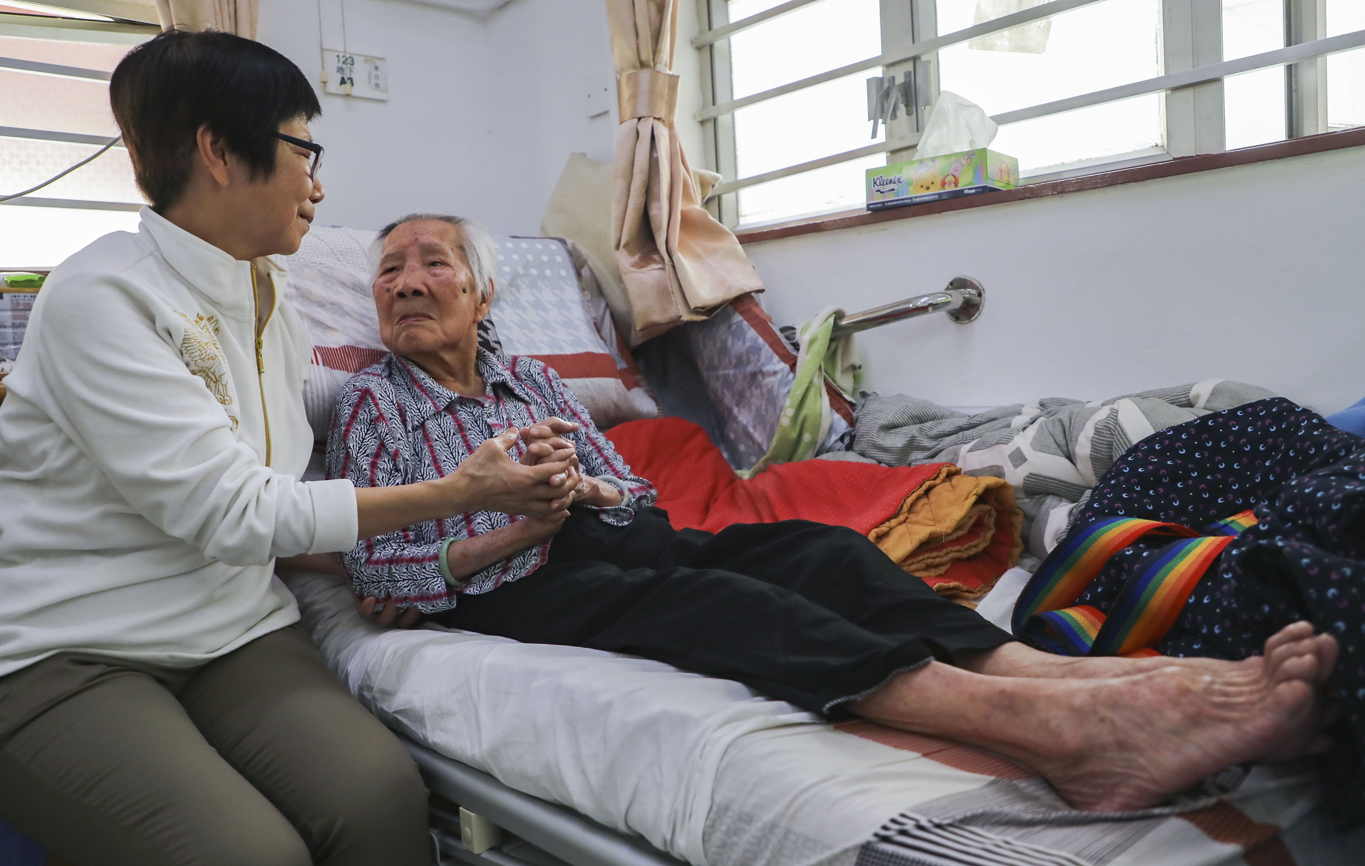 A woman visits her elderly mother in a care home in Tuen Mun. The demand for elderly care in Hong Kong outstrips the supply of affordable care options, and “ageing in place”, where elderly people live in their own homes, is seen as a solution. Photo: Edward Wong