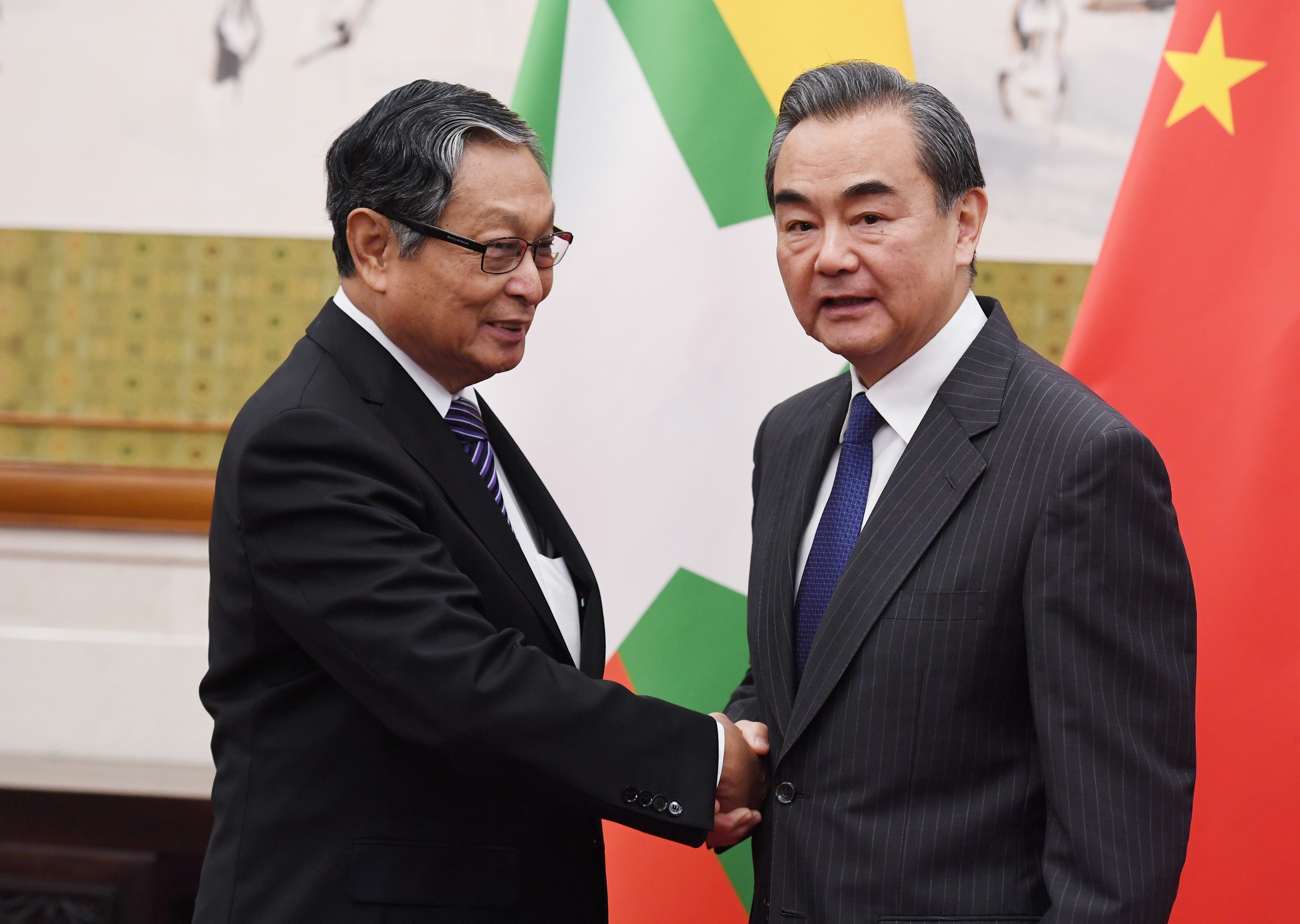 Chinese Foreign Minister Wang Yi (right) shakes hands with Myanmar's Minister for the Office of the State Counsellor Kyaw Tint Swe in Beijing on June 28. Photo: Reuters