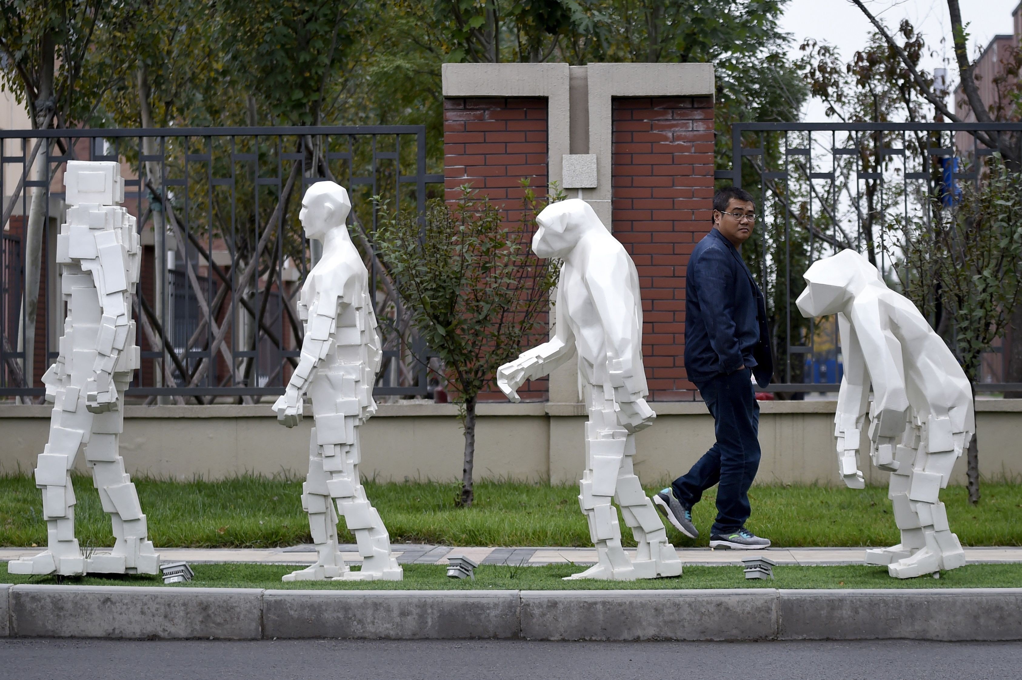 A man walks past sculptures outside Xianghe Robot Industry Port in China’s Hebei province in October 2017. The Made in China 2025 plan has ruffled feathers in the West, but it will take a commitment of time, talent and money for the country to become a true technology leader. Photo: AFP
