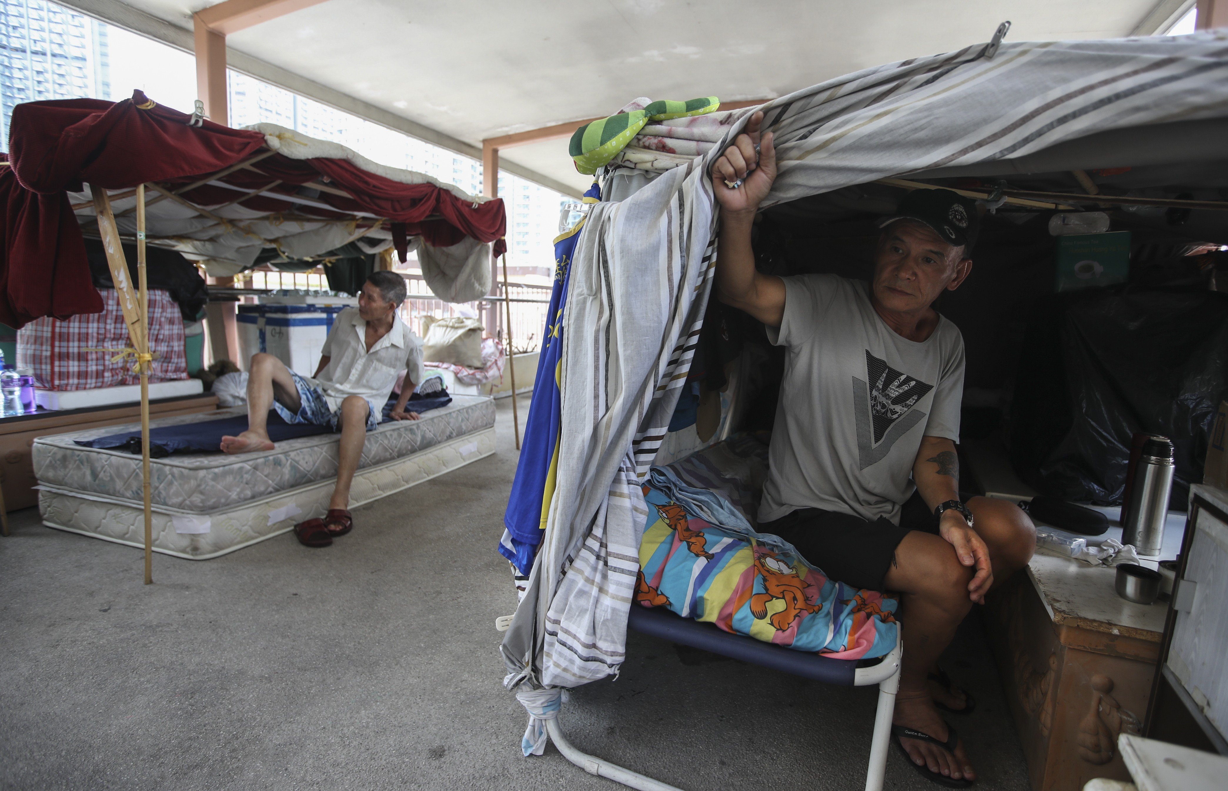 Nguyen Van Son and his neighbours on a footbridge in Sham Shui Po, Hong Kong’s poorest district, have limited options after packing up their shelters: a subdivided flat, a ‘coffin home’, or another street berth