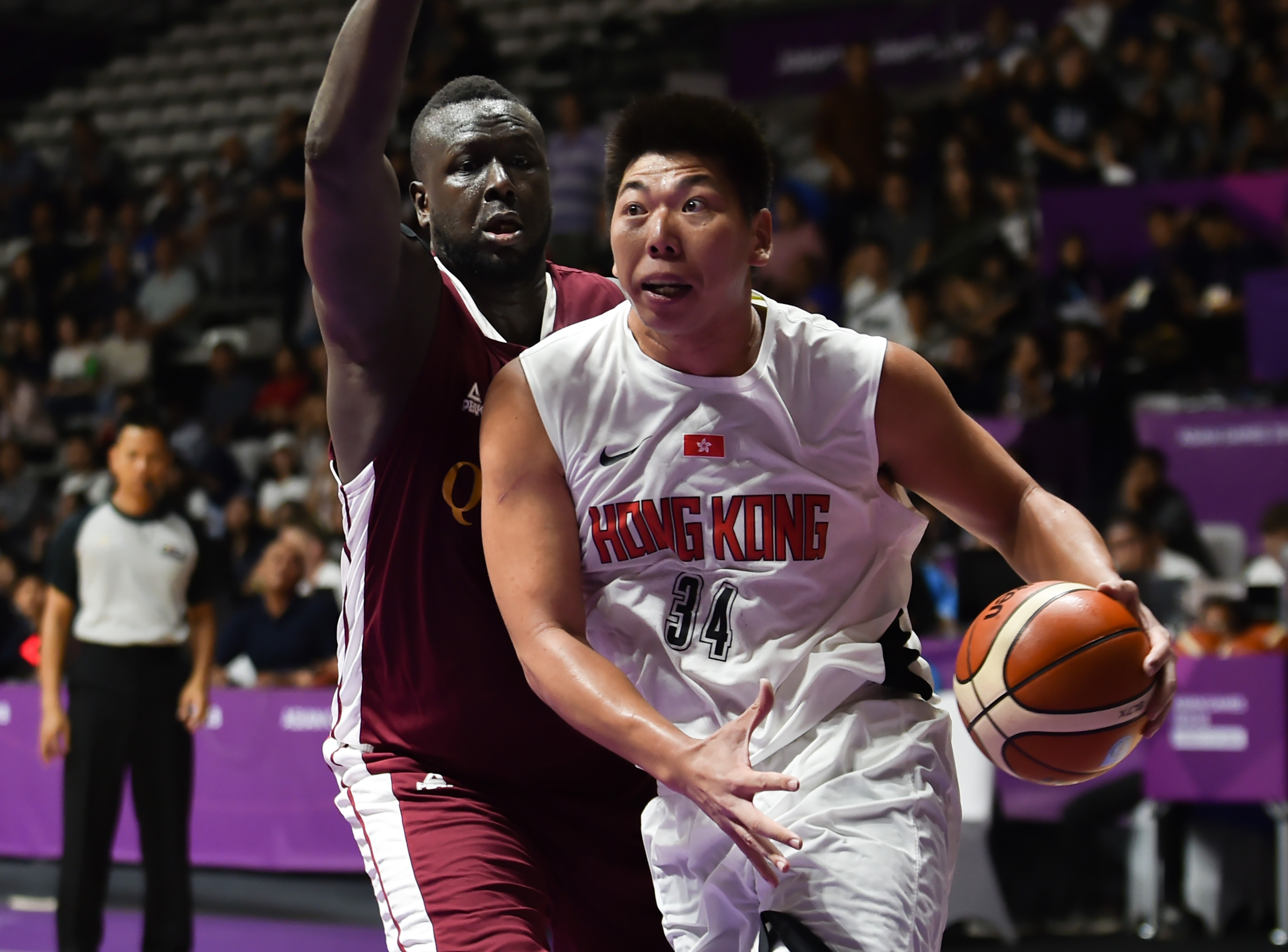 Hong Kong's Szeto Wai-kit manoeuvres past Qatar's Mohd Mohammed during their group C game at the Asian Games in Jakarta. Photos: AFP