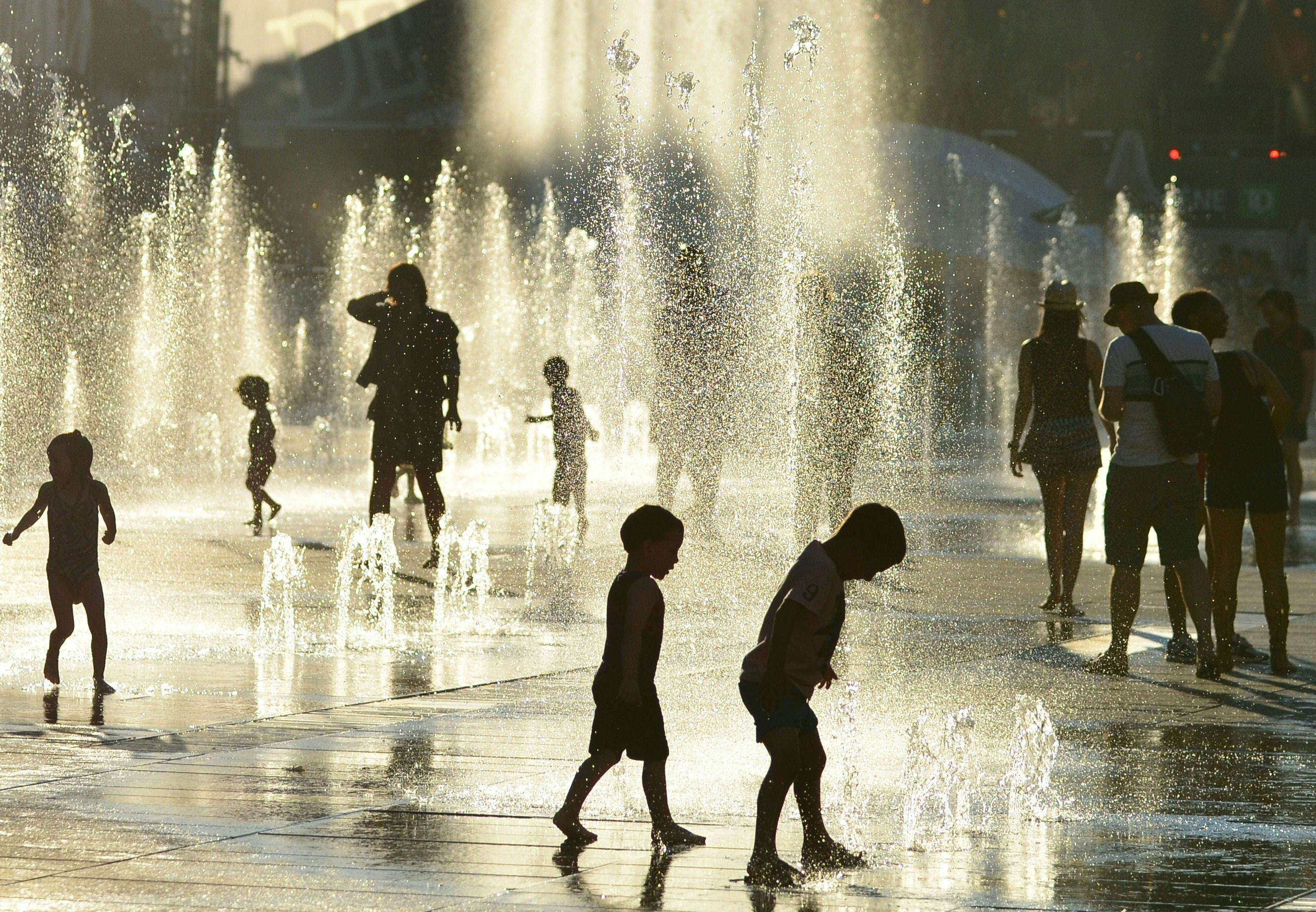 Children cool off in fountains at the Place des Arts in Montreal, Canada, in July. Picture: AFP