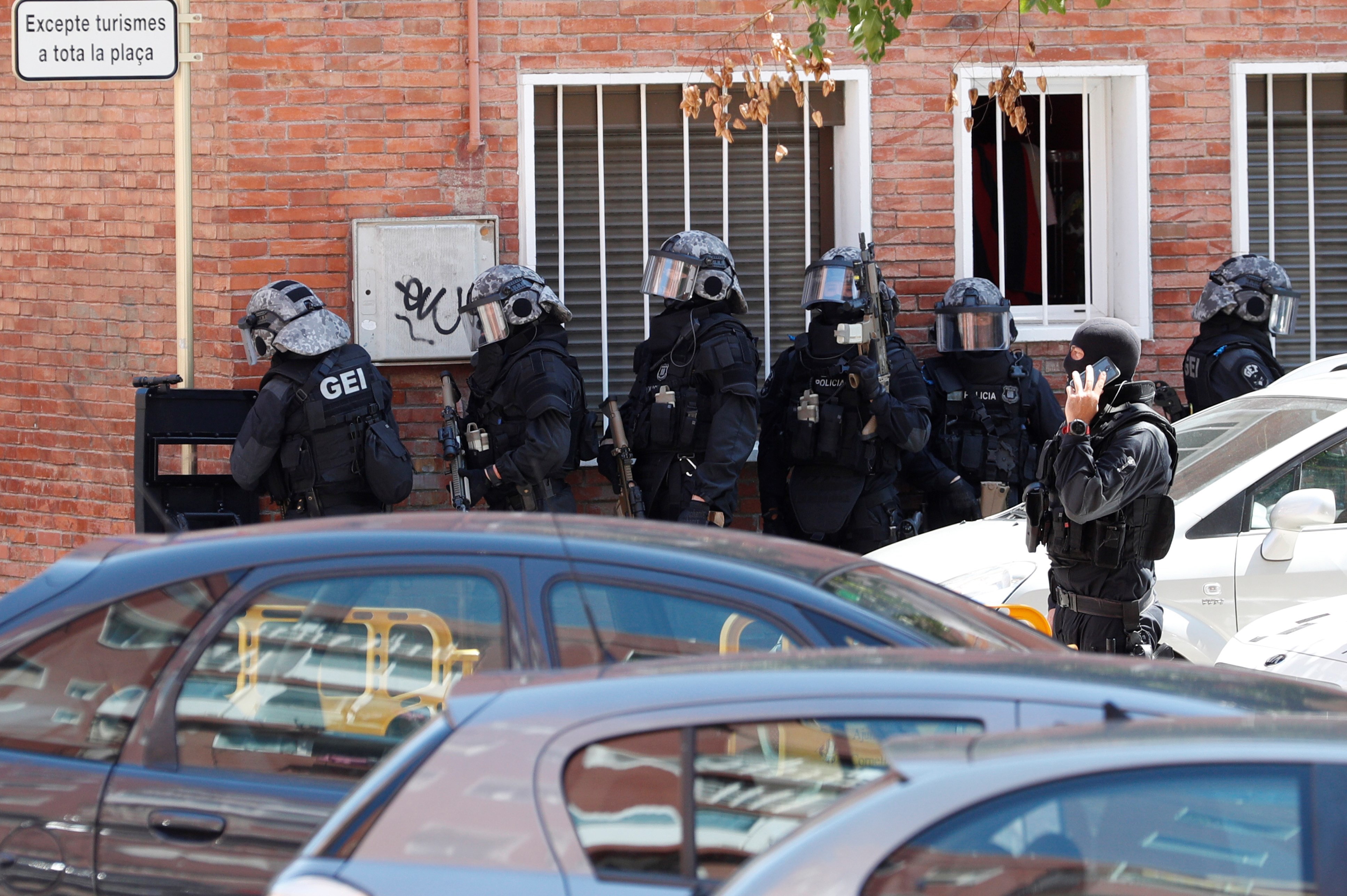 Officers take part in the search of the residential building where the attacker lived in Cornella, Spain. Photo: EPA-EFE