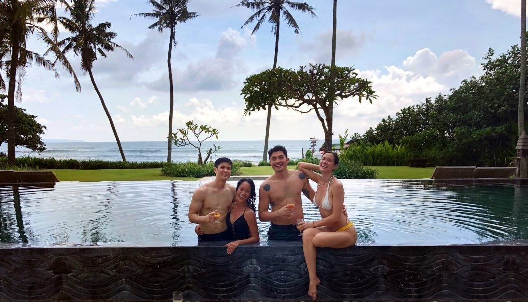Harry Shum (far left), with his wife Shelby Rabara, and Henry Golding (centre), with his wife Liv Lo, relax with The Luxe Nomad in Bali. Photo: The Luxe Nomad