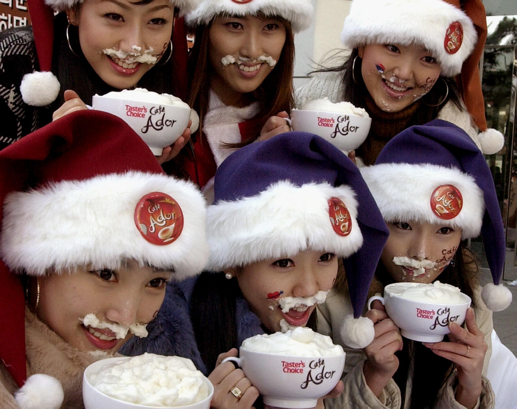 South Korean models drink coffee during a promotional event in Seoul. The government has banned coffee in the country’s schools for health reasons. Photo: AFP