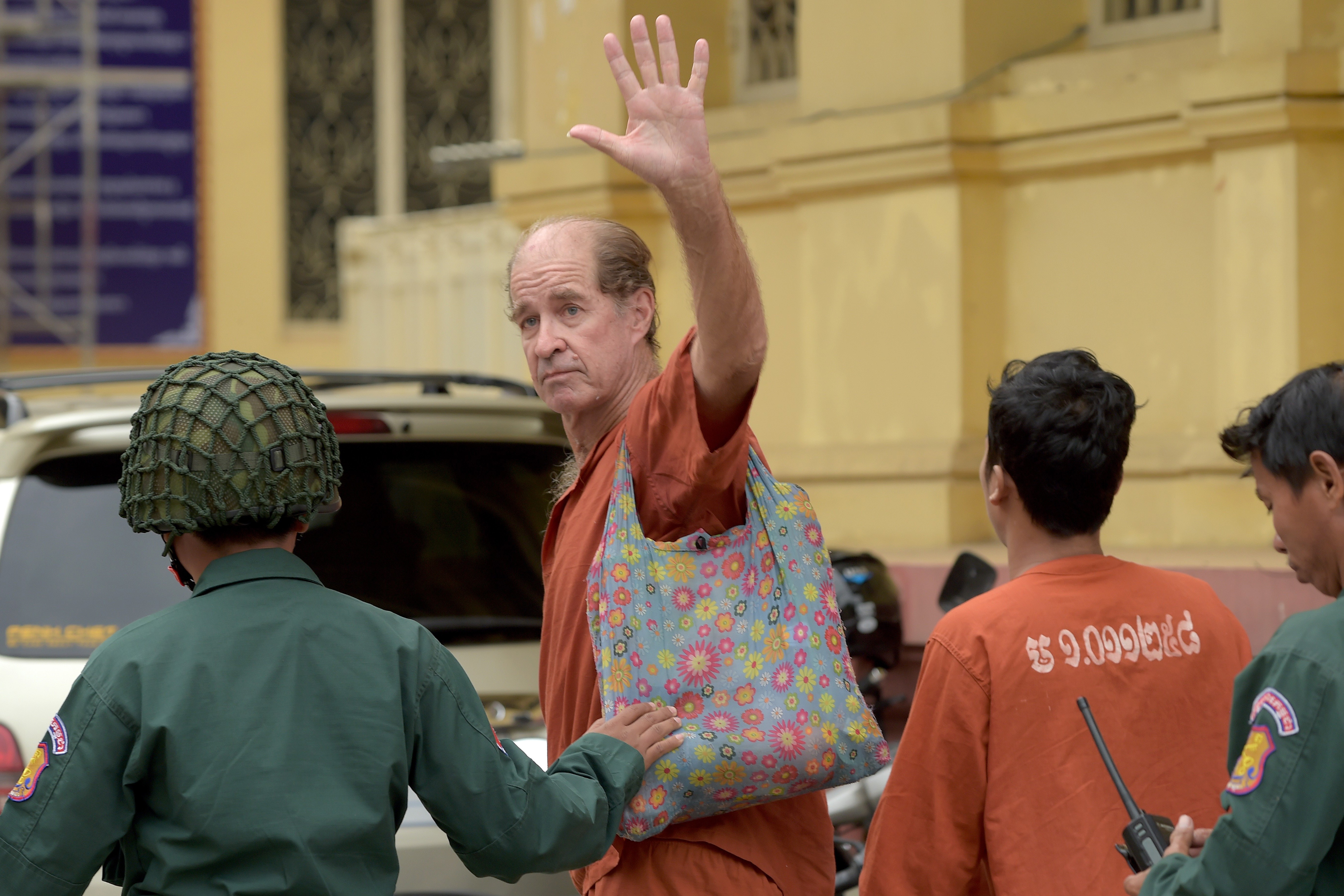Australian James Ricketson gestures as Cambodian prison guards escort him to the Supreme Court for a bail hearing in Phnom Penh on January 17. He was sentenced to six years for allegedly spying on Cambodia of ‘foreign states’. Photo: AFP