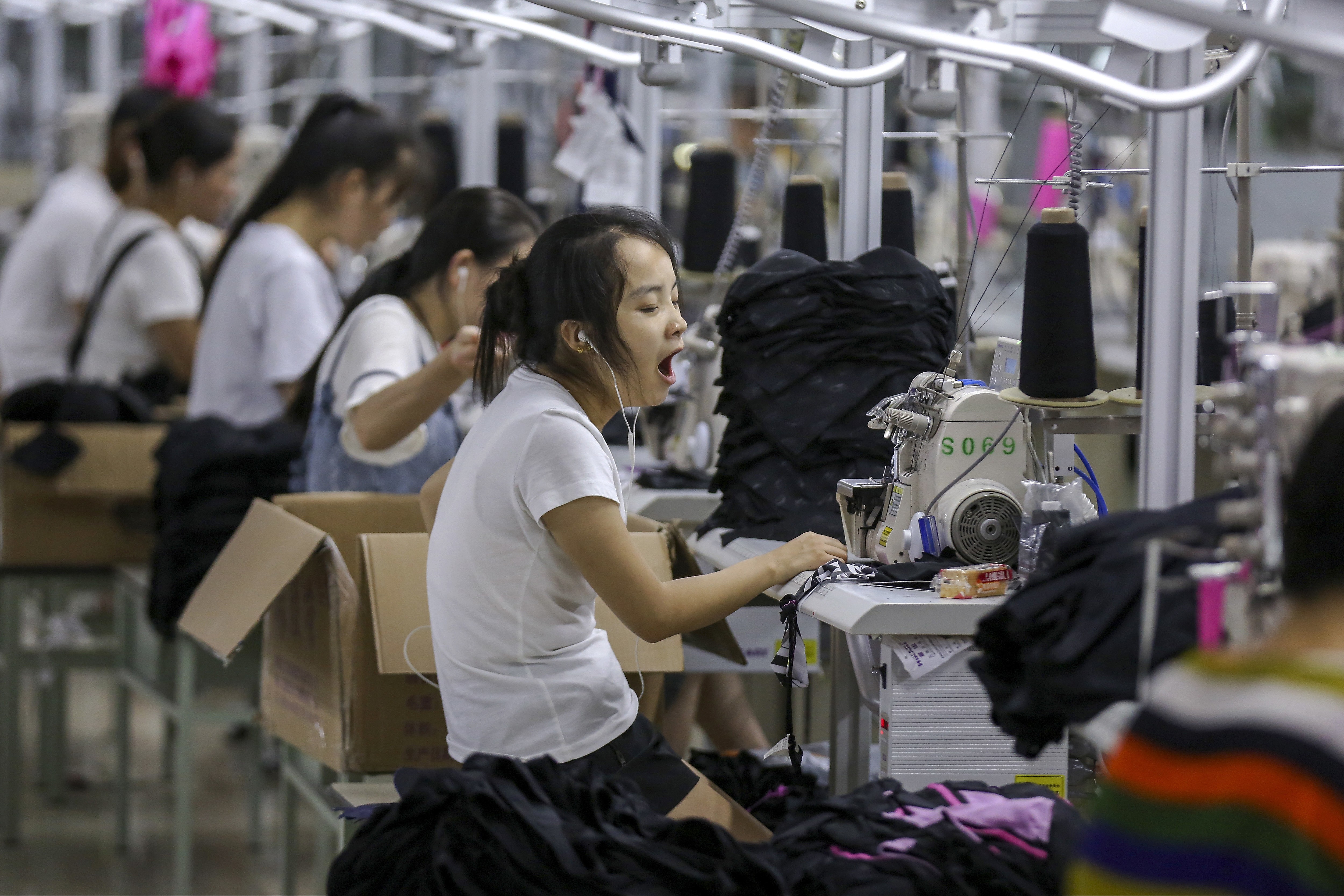 Workers sew swimsuits at a factory in Jinjiang city, Fujian province, this month. The Chinese economy is unmistakably slowing, but the slowdown this year – a result of policies aimed at ensuring financial stability and a natural rollover in momentum after a strong 2017 – is mild. Photo: Chinatopix via AP
