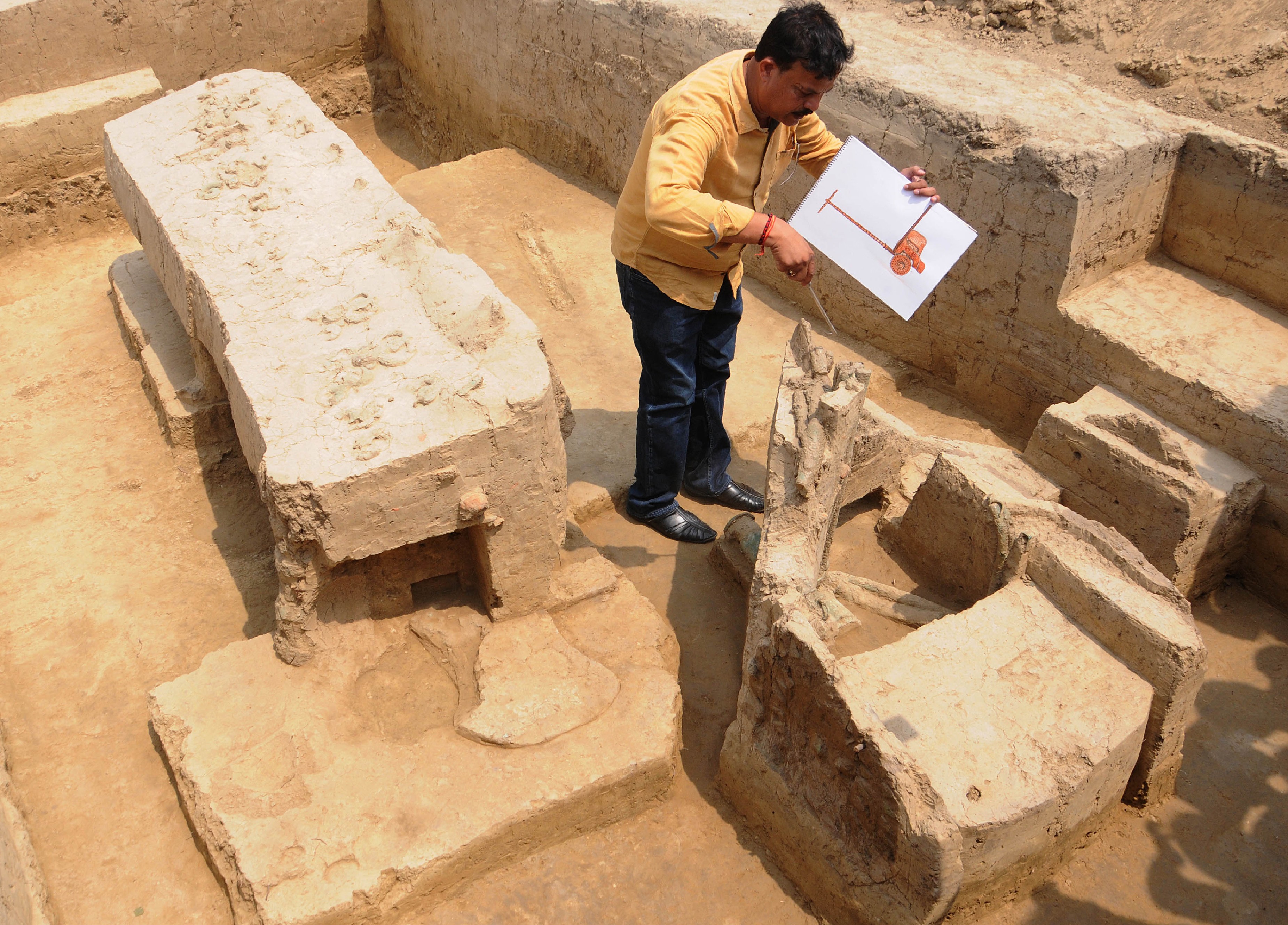 An archaeologist looks at the remains of a chariot belonging to the Indus Valley civilisation at an excavation site in Baghpat. Photo: AFP