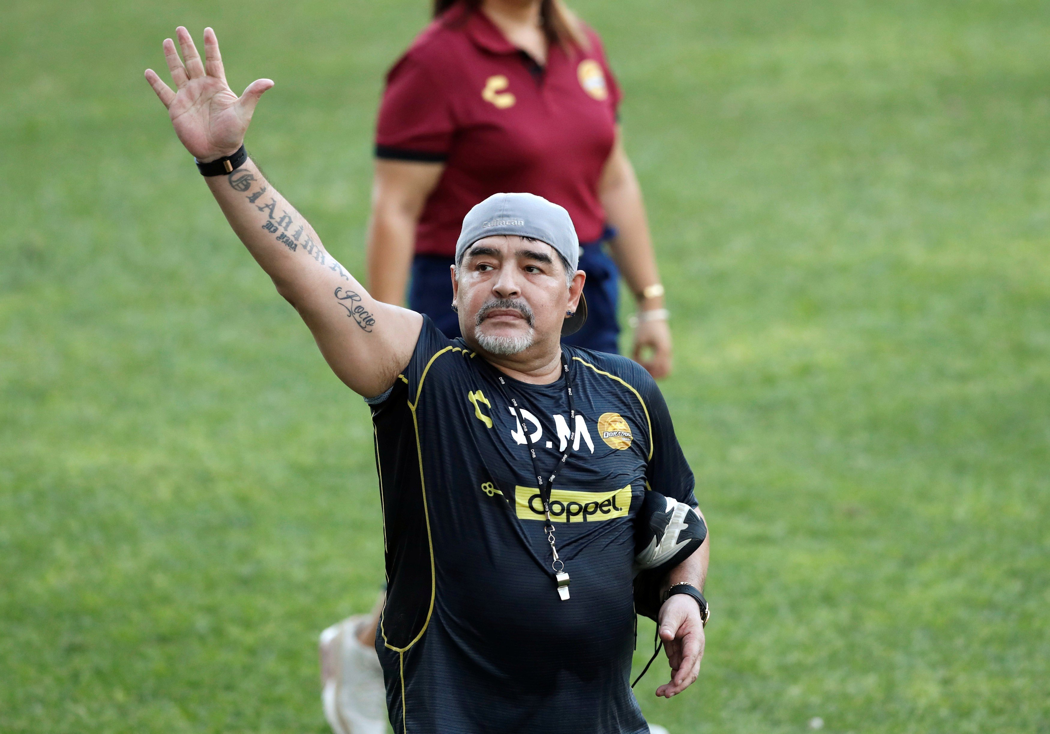Argentinian soccer legend Diego Armando Maradona waves to fans during his first training session as coach of Dorados. Photo: Reuters