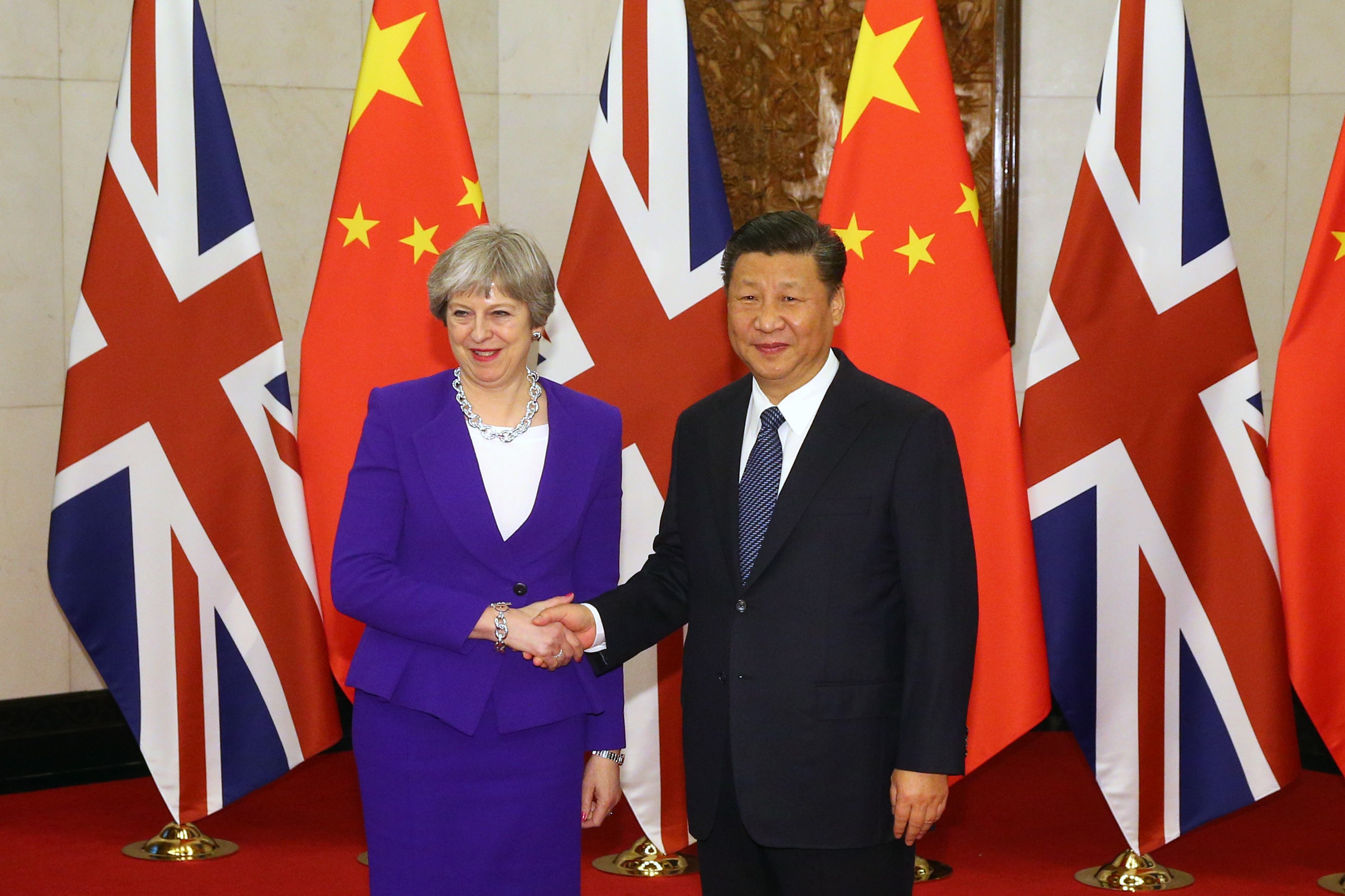 Chinese President Xi Jinping shakes hands with Britain's Prime Minister Theresa May ahead of their meeting at the Diaoyutai State Guesthouse in Beijing on February 1, 2018. Photo: AFP