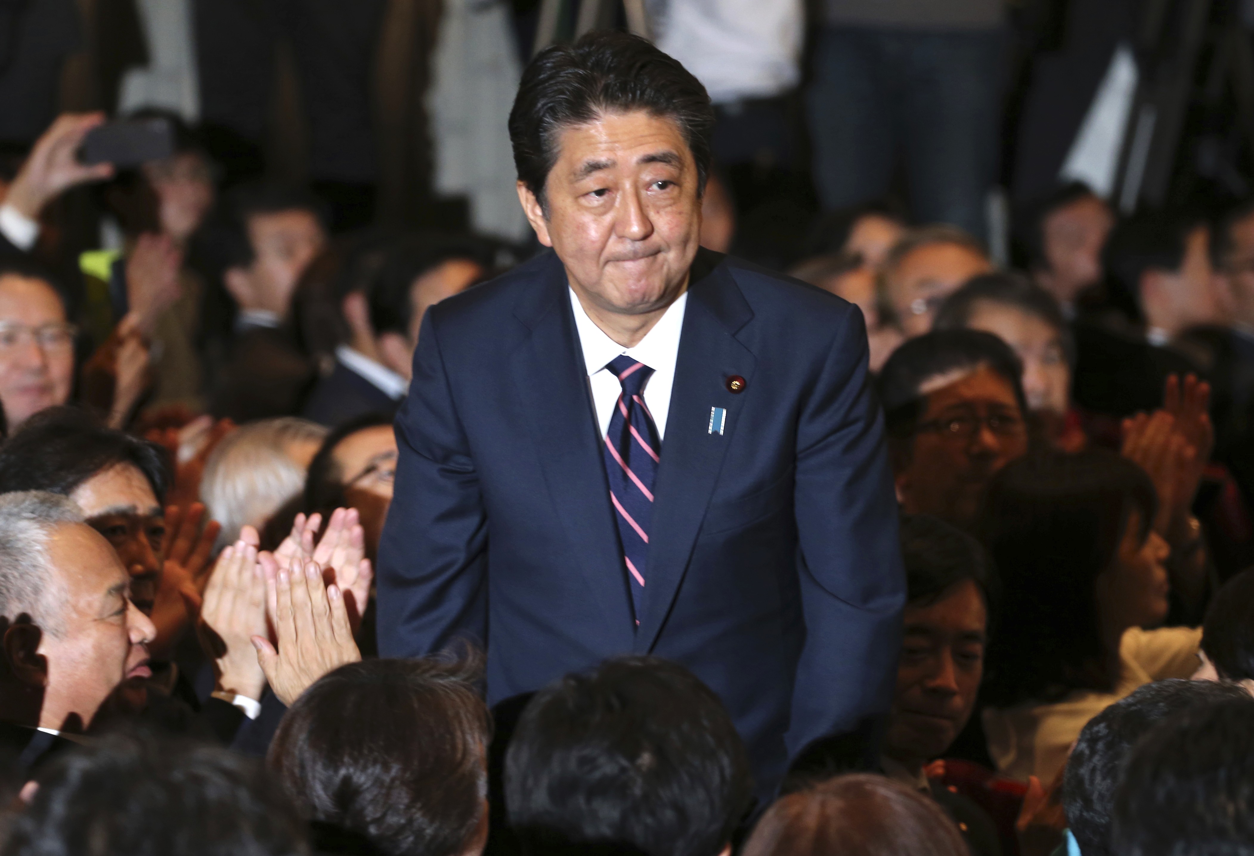 Liberal Democratic Party President Shinzo Abe receives applause from the LDP lawmakers soon after winning a third term as LDP leader, paving the way for him to serve as prime minister for up to three more years. Photo: AP