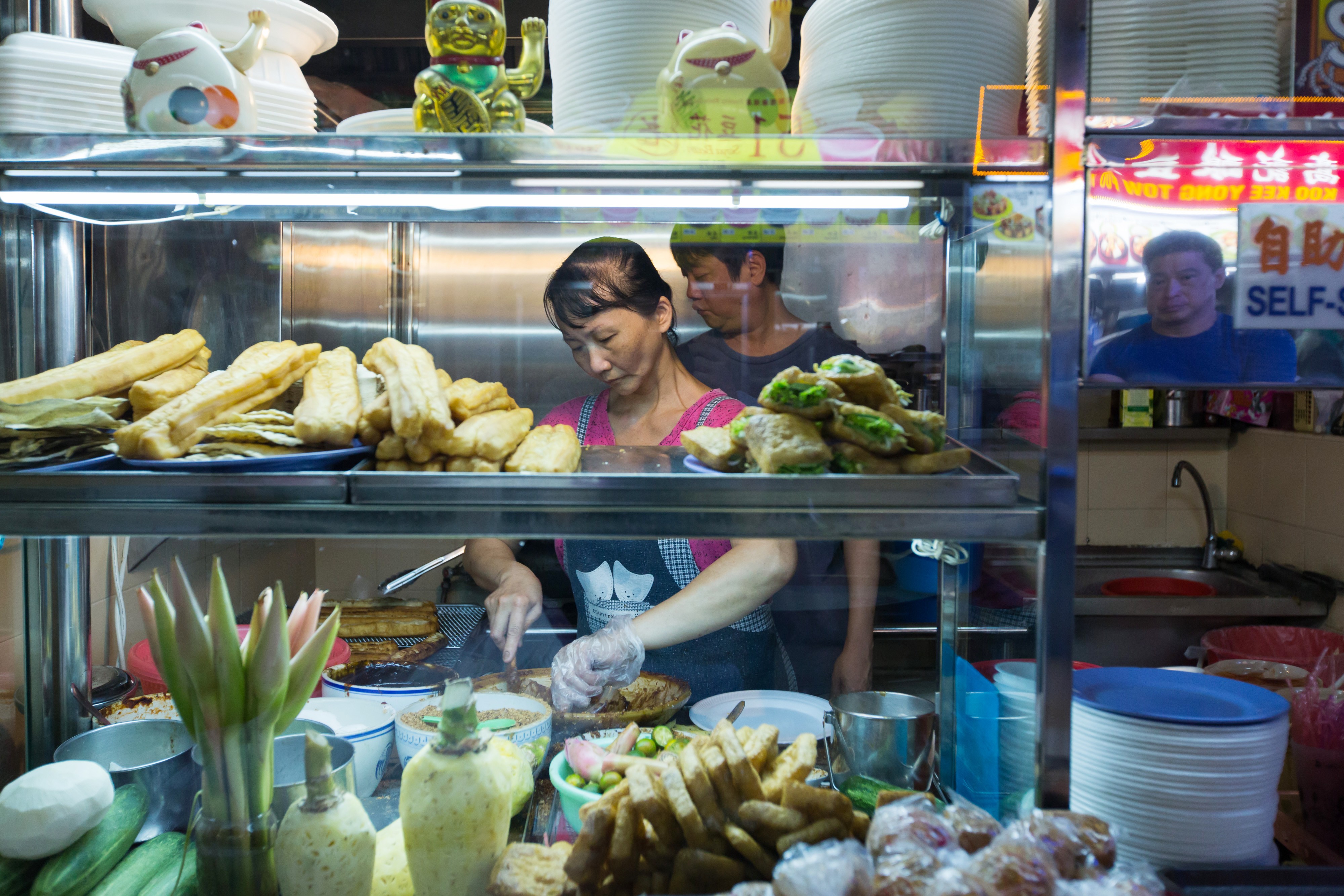 A vendor prepares food at a stall in the Old Airport Road Food Centre in Singapore. Photo: Bloomberg