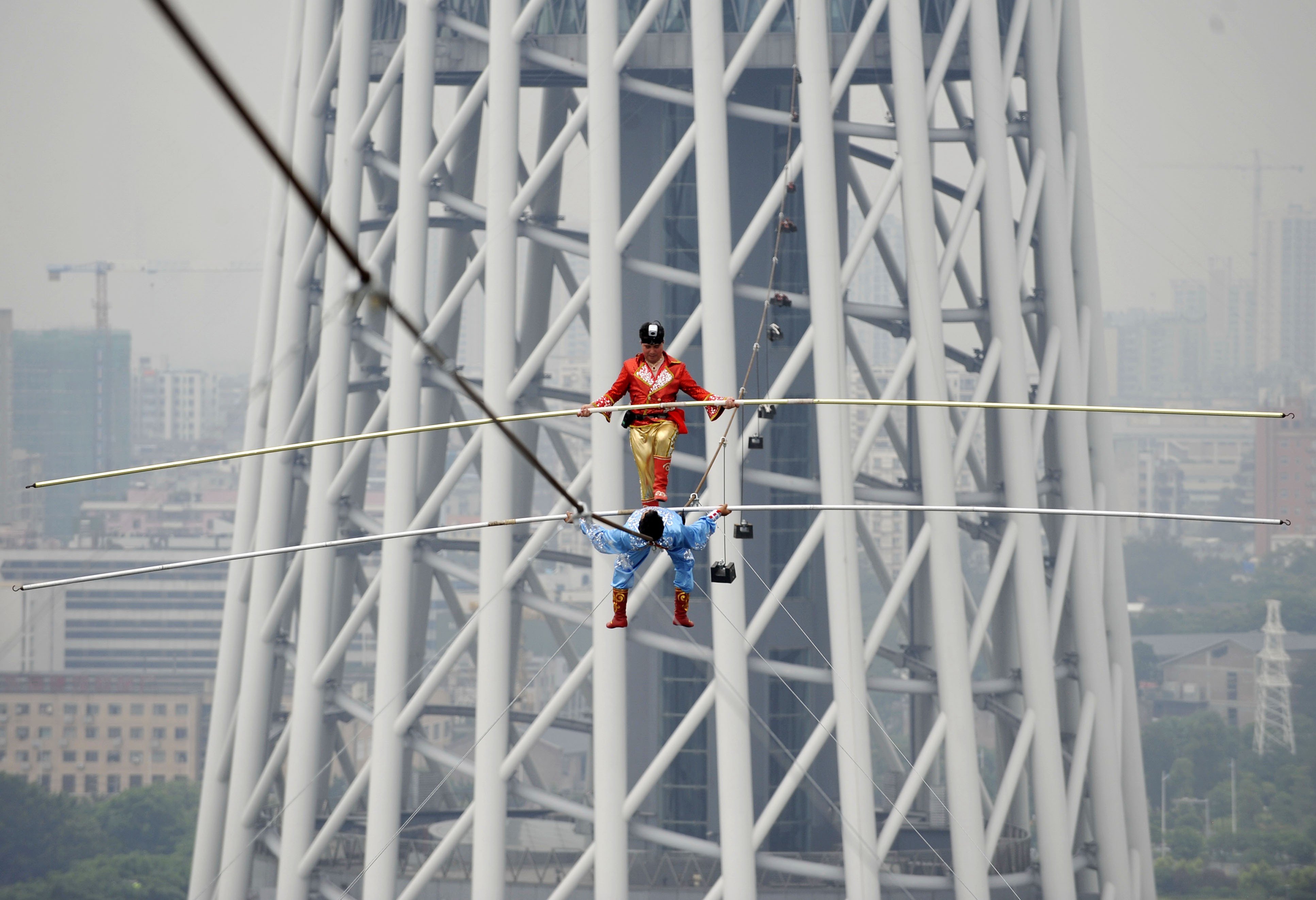This feat by tightrope walkers 100m above the Pearl River in Guangzhou is nothing compared to the difficult balancing act China needs to achieve between political centralisation and economic decentralisation. Photo: Xinhua