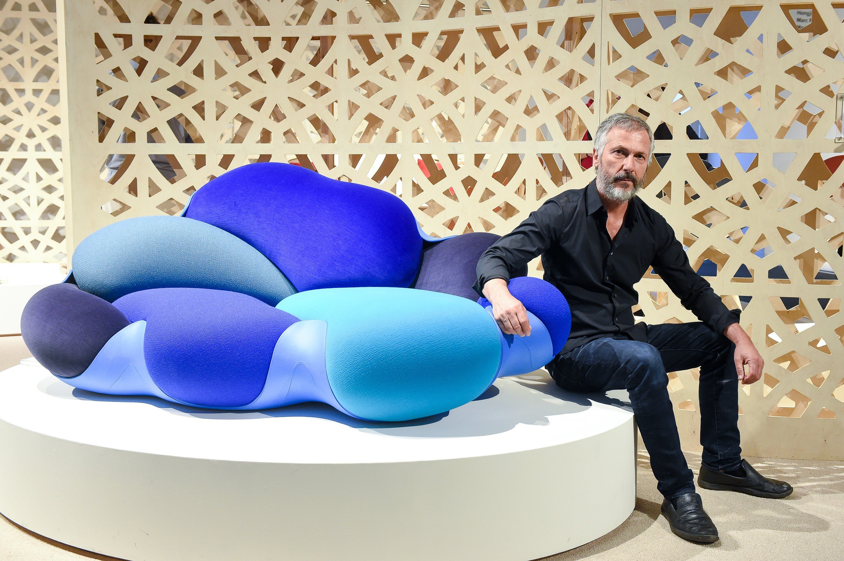 Humberto Campana and the Bomboca Sofa, a riot of organic shapes in shades of sea and sky, named after the confectionery served at Brazilian weddings. The sofa was designed for Louis Vuitton by Humberto and Fernando Campana. Photo: Joe Schildhorn/BFA.com