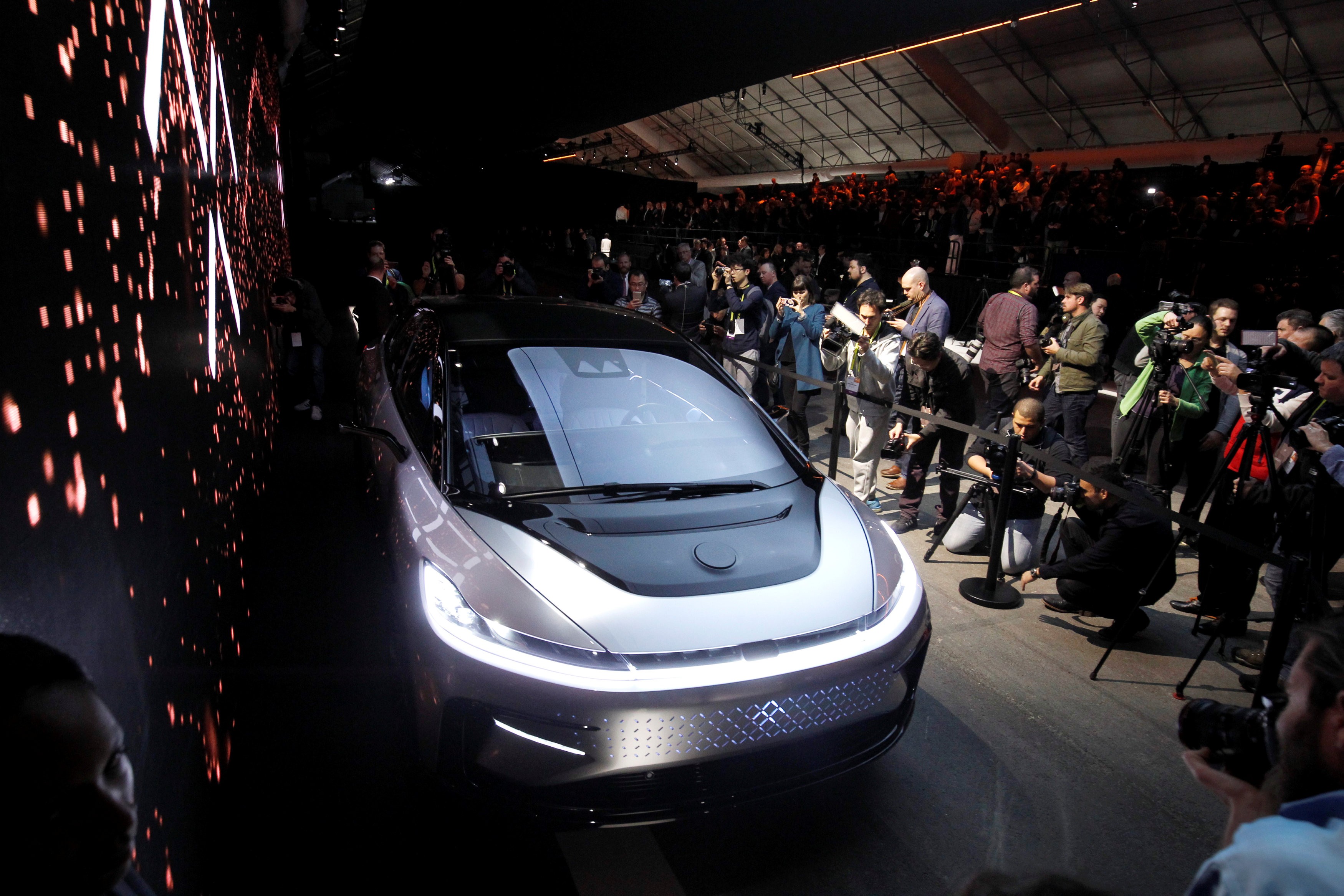 Journalists gather around a Faraday Future FF 91 electric car during an unveiling event at CES in Las Vegas, on January 3, 2017. Photo: Reuters
