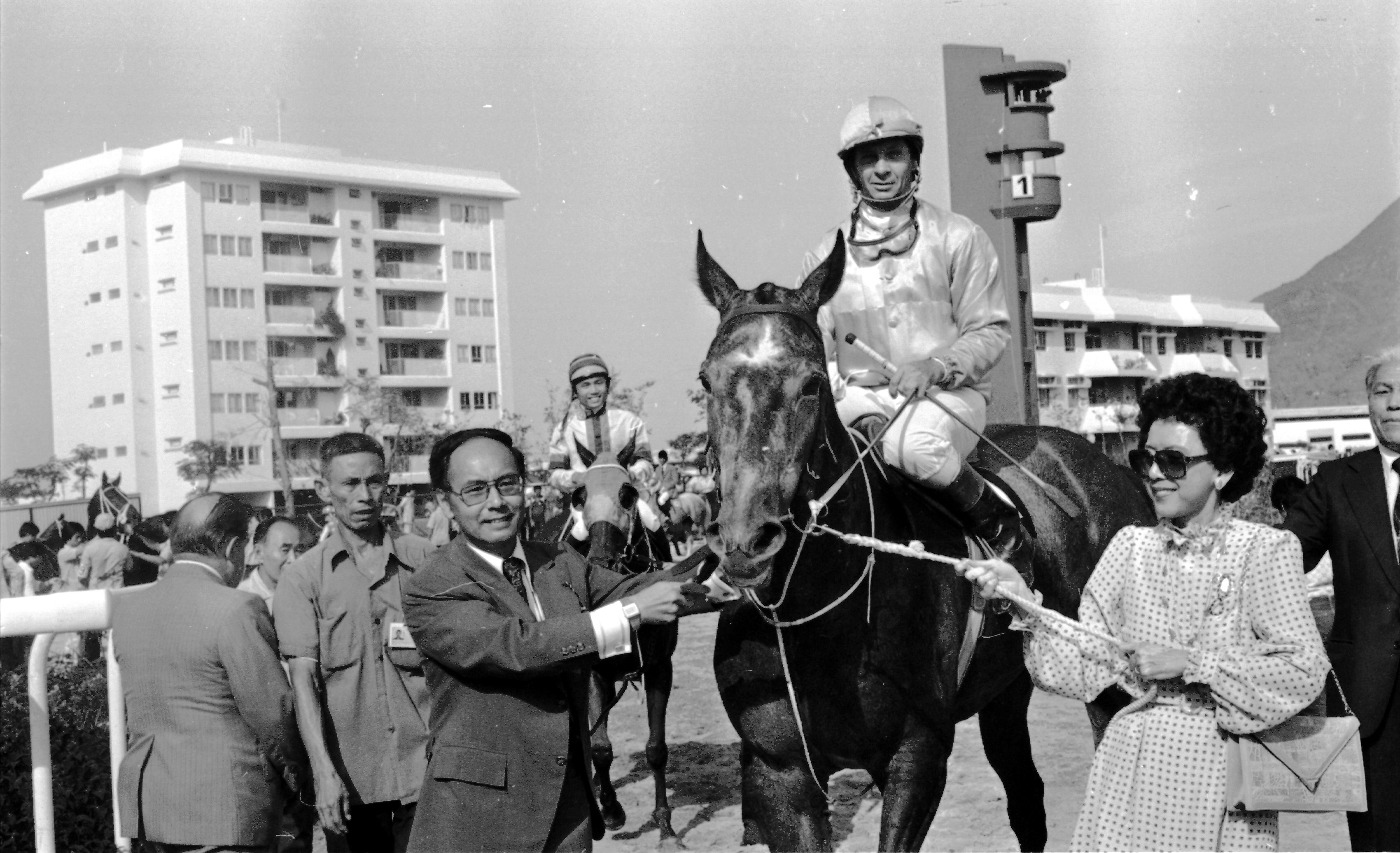 Sanford and Marlene Yung lead Silver Lining, ridden by Bill Hartack, after winning the Sha Tin Trophy on the opening day of Sha Tin Racecourse. Pictures: SCMP
