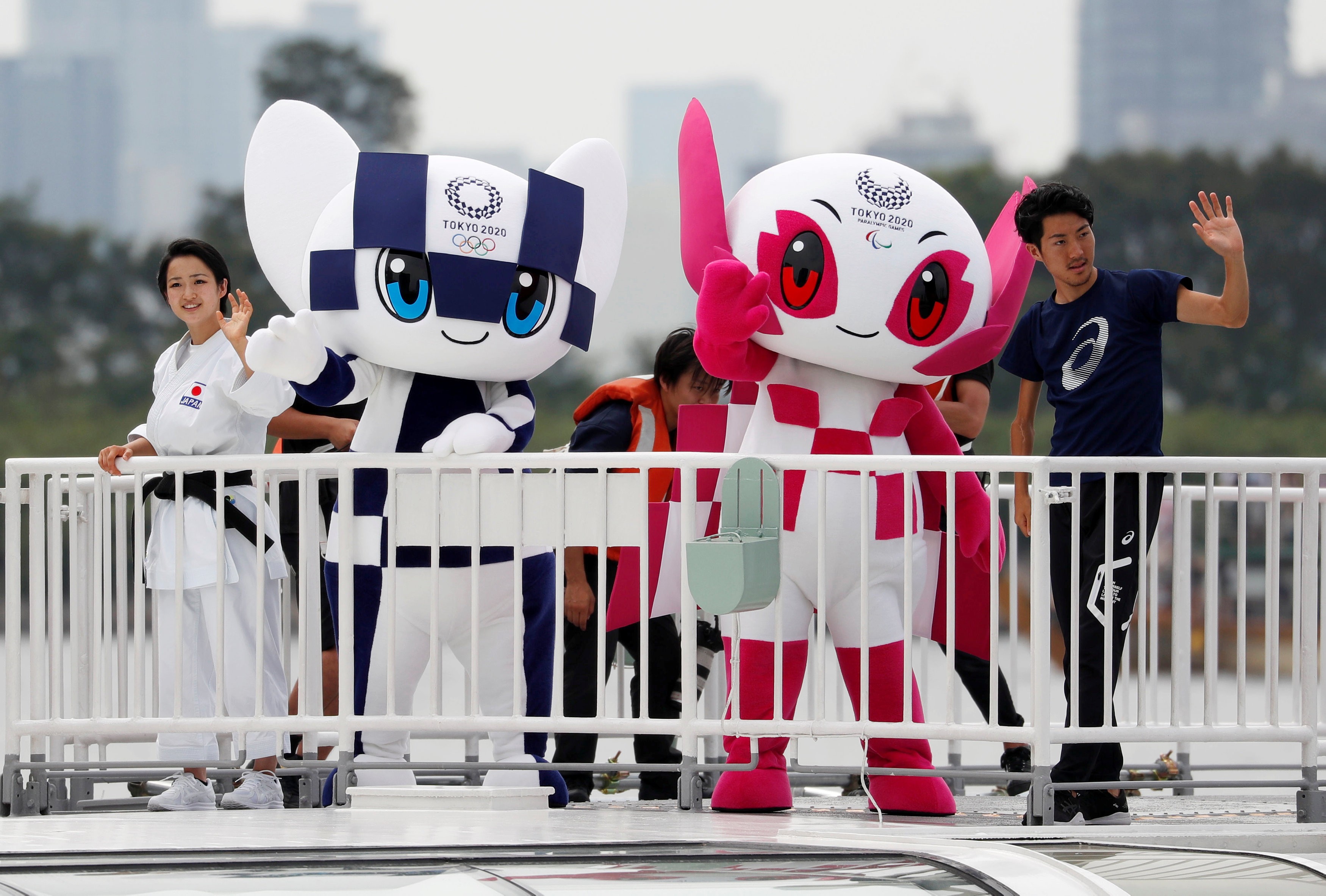 Tokyo 2020 Olympic Games mascot Miraitowa and Paralympic mascot Someity wave with Japan's Paralympic long-jumper Hajimu Ashida and karateka Kiyo Shimkizu in Tokyo in July. Photo: Reuters