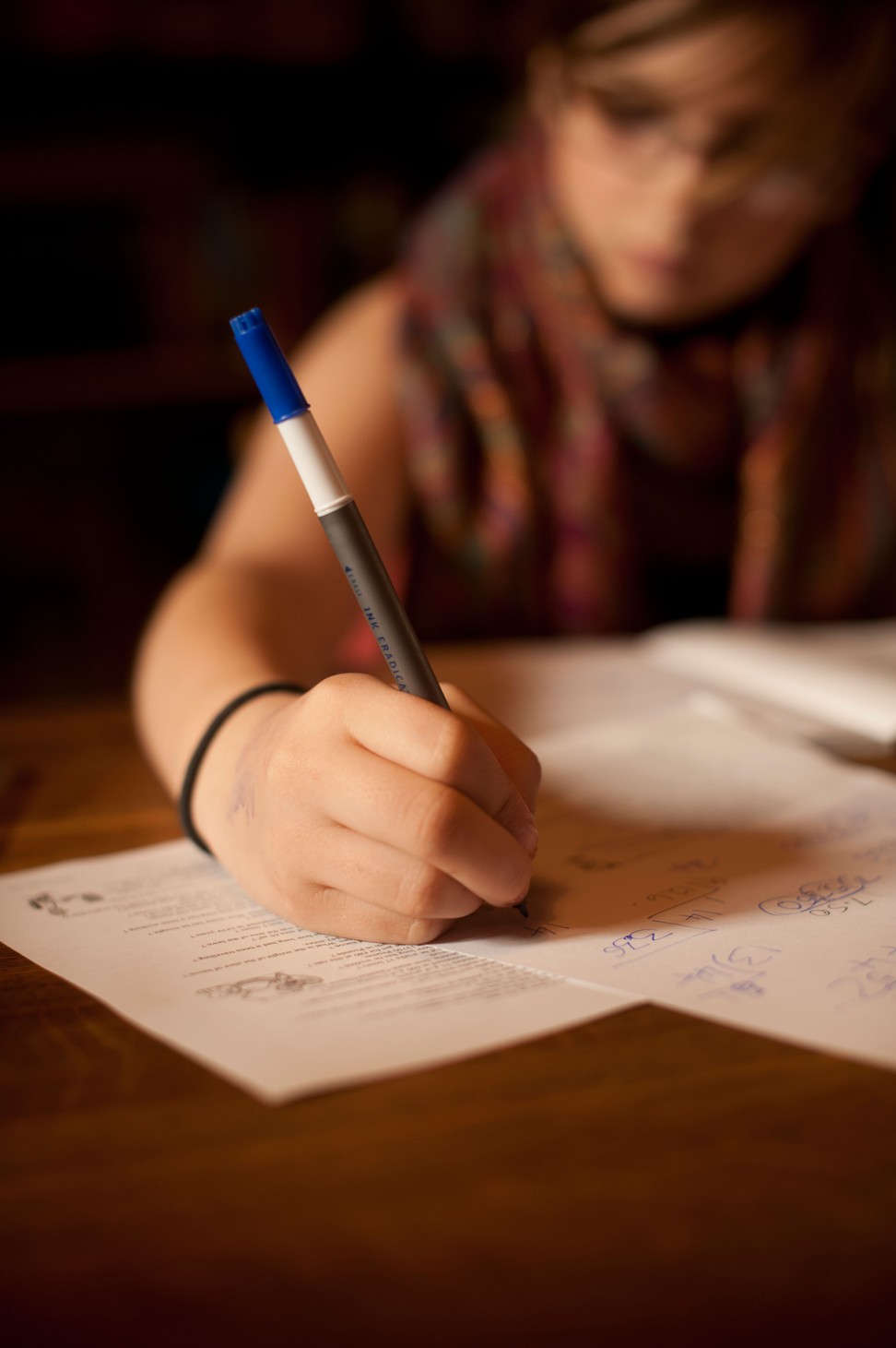 C43720 A 12 13 year old girl doing her mathematics homework at home Photo: Alamy