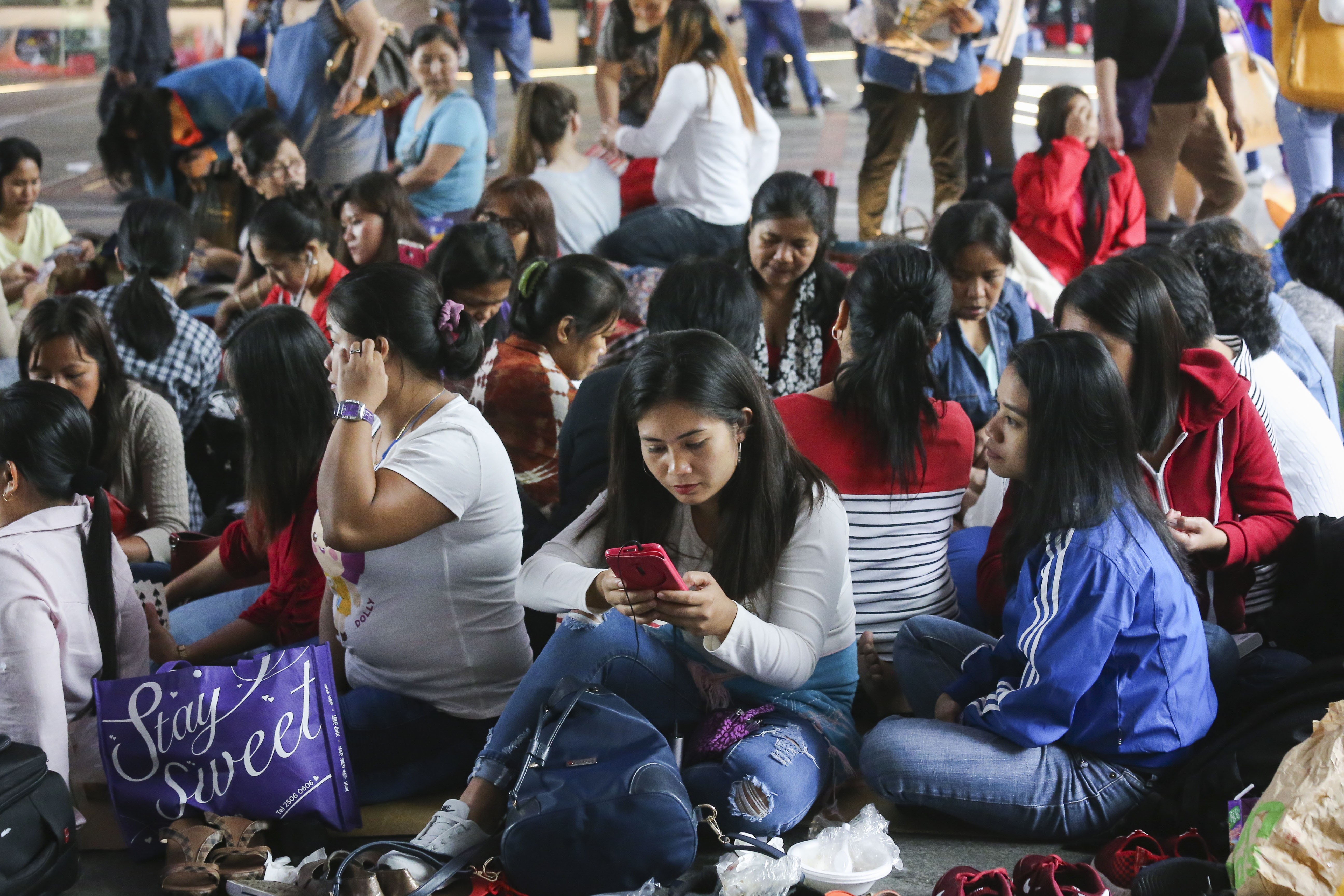 Filipino domestic workers sit on a street on a Sunday in Hong Kong. Photo: Dickson Lee