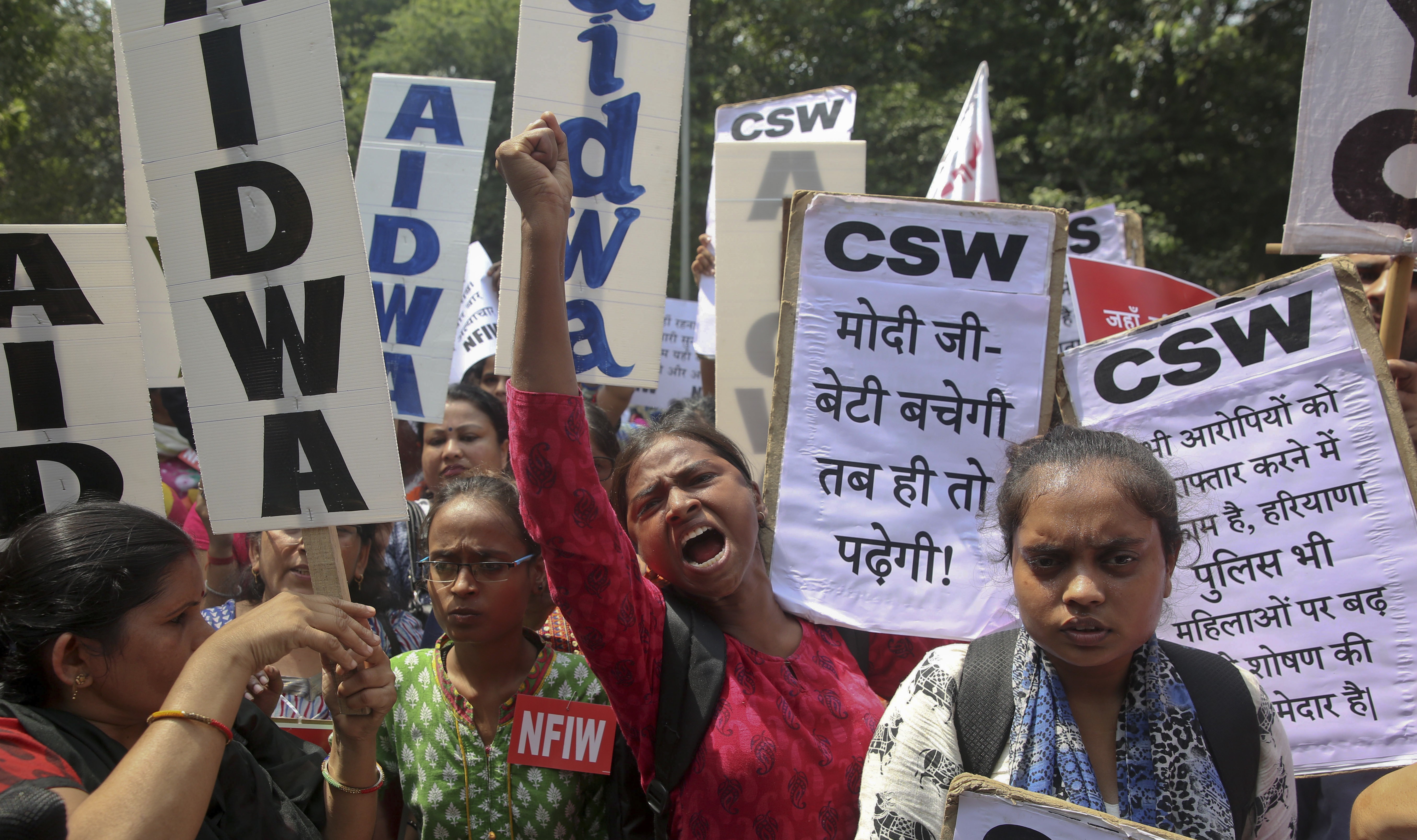 Women activists shout slogans condemning the rape of a nineteen-year old girl while protesting in New Delhi, India, in September. Photo: AP