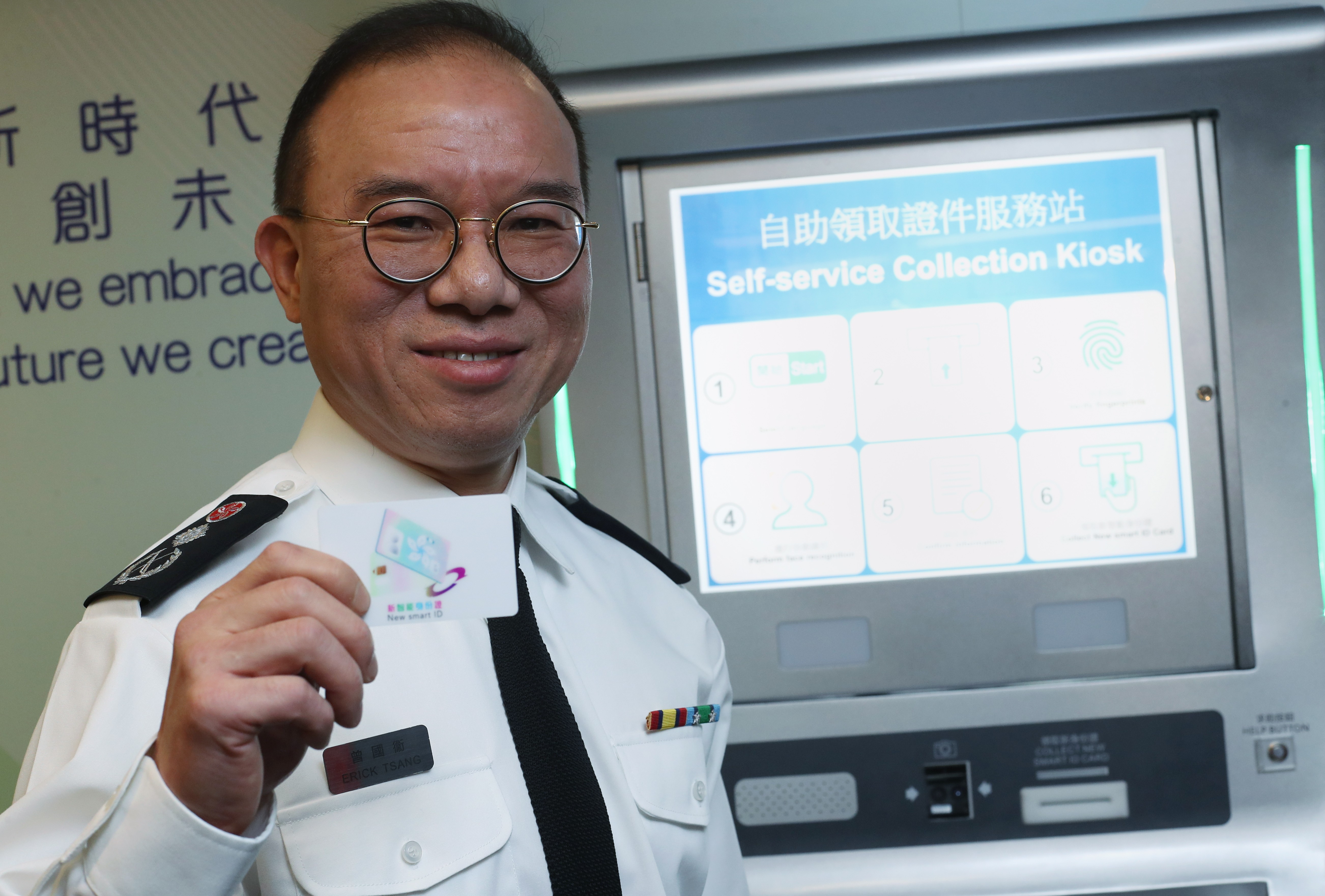 Immigration Department deputy director Erick Tsang Kwok-wai with an early version of the next smart ID card to be issued in Hong Kong this December. Photo: Winson Wong