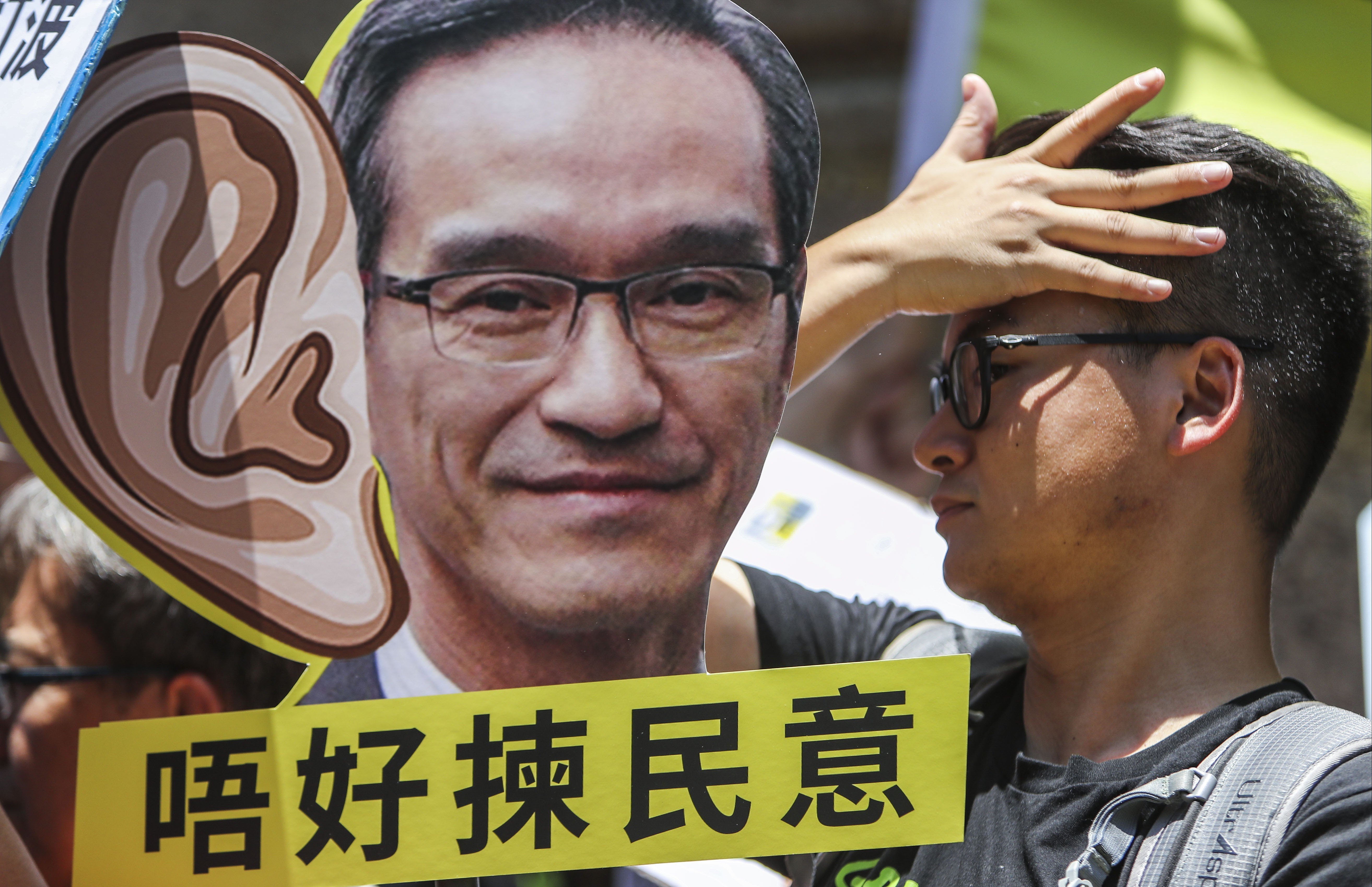 Protesters rally at the Leighton Hill Community Hall in Happy Valley during a public forum organised by the Task Force on Land Supply in June. The land supply public consultation is one of the most high-profile public engagement exercises held this year. Photo: Winson Wong