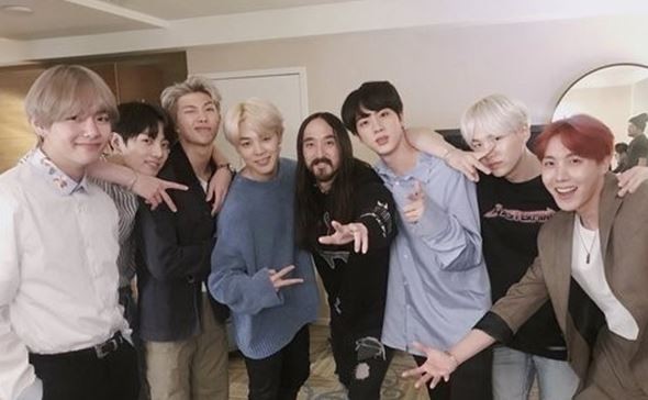 American musician, DJ and music producer Steve Aoki (centre, with a beard and moustache) and the seven members of K-pop boy band BTS, who have teamed up on the new single, ‘Waste It On Me’. Photo: Steve Aoki’s Twitter