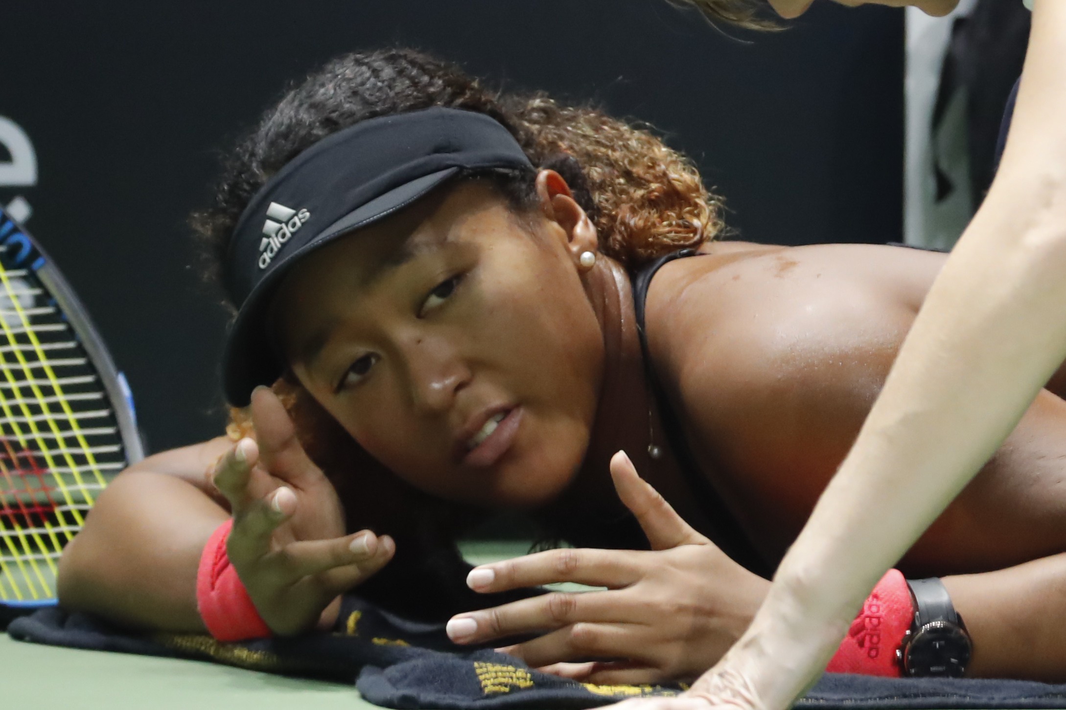 Naomi Osaka receives treatment on the court during a medical timeout against Kiki Bertens at the WTA Finals in Singapore. Photo: AP