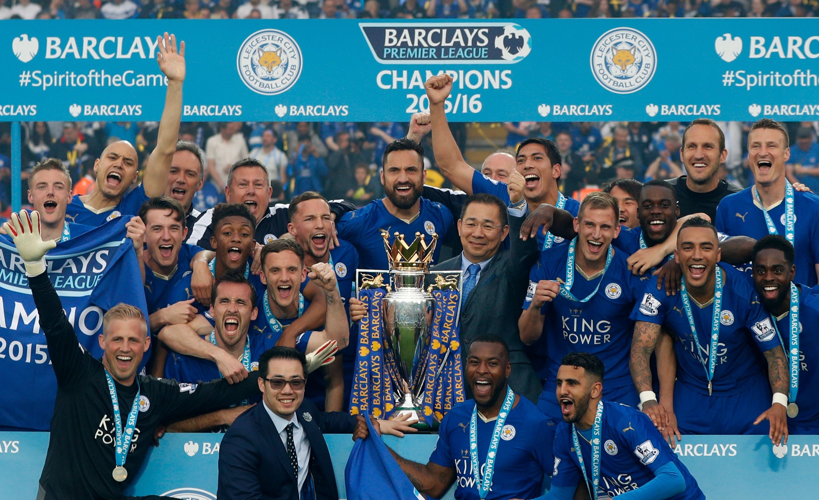 Leicester City players and chairman Vichai Srivaddhanaprabha (C) a pose with the Premier league trophy after winning the league. Photo: AFP