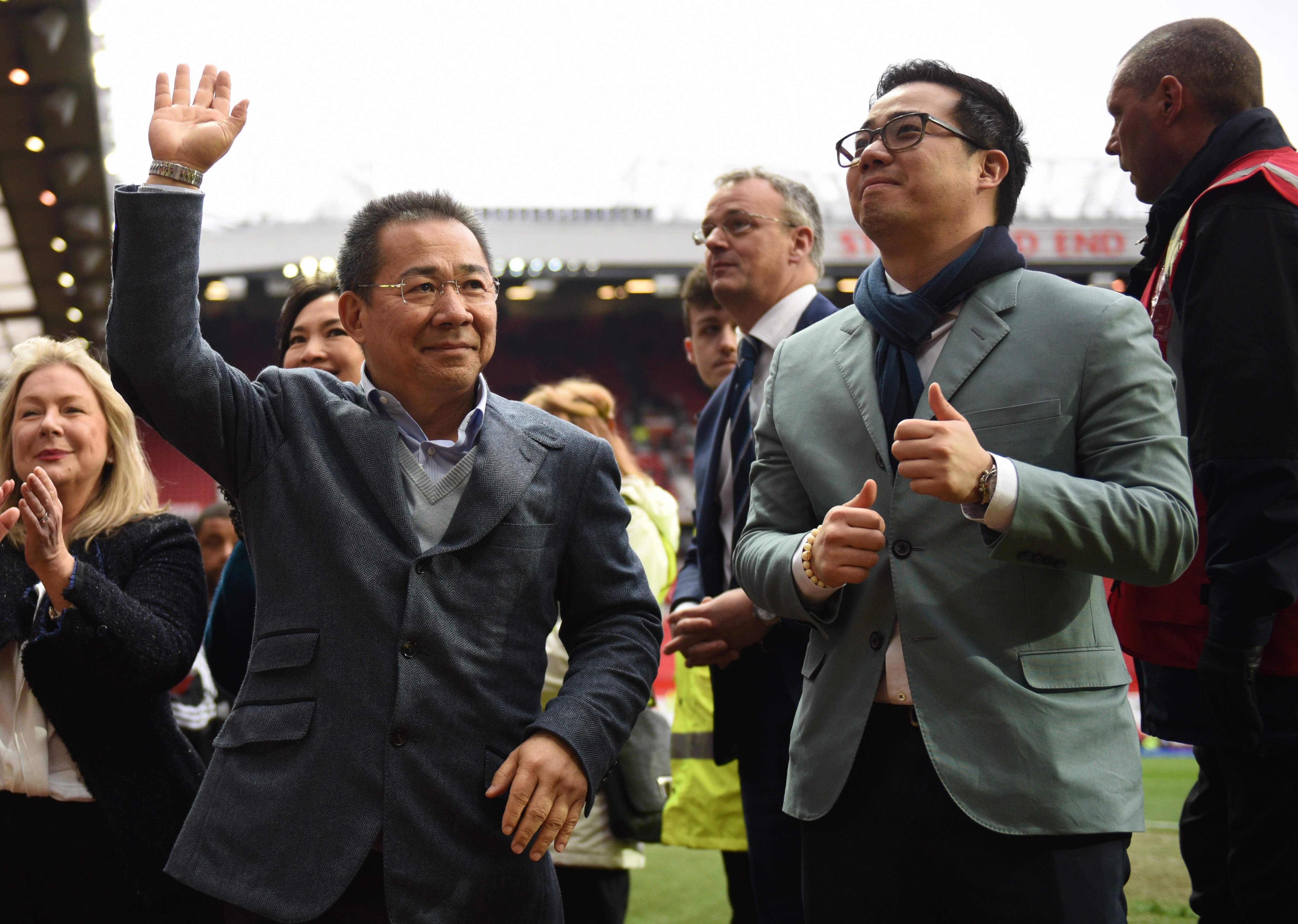 Leicester City's Thai chairman Vichai Srivaddhanaprabha (L) waves to fans next to son Aiyawatt Srivaddhanaprabha (R) after the English Premier League match against Manchester United in May, 2016. Photo: AFP