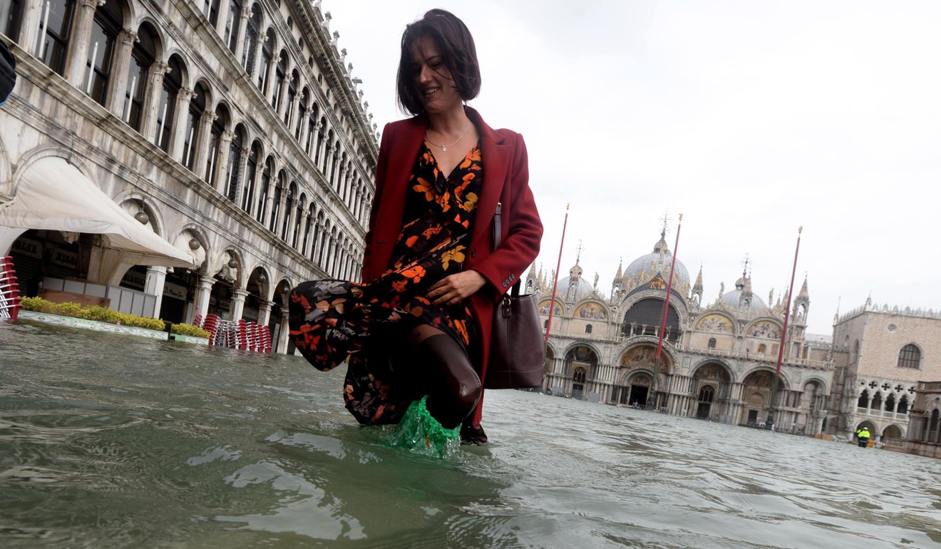 Tourists wade through Venice as 70 per cent of city is immersed by the  worst flooding in a decade