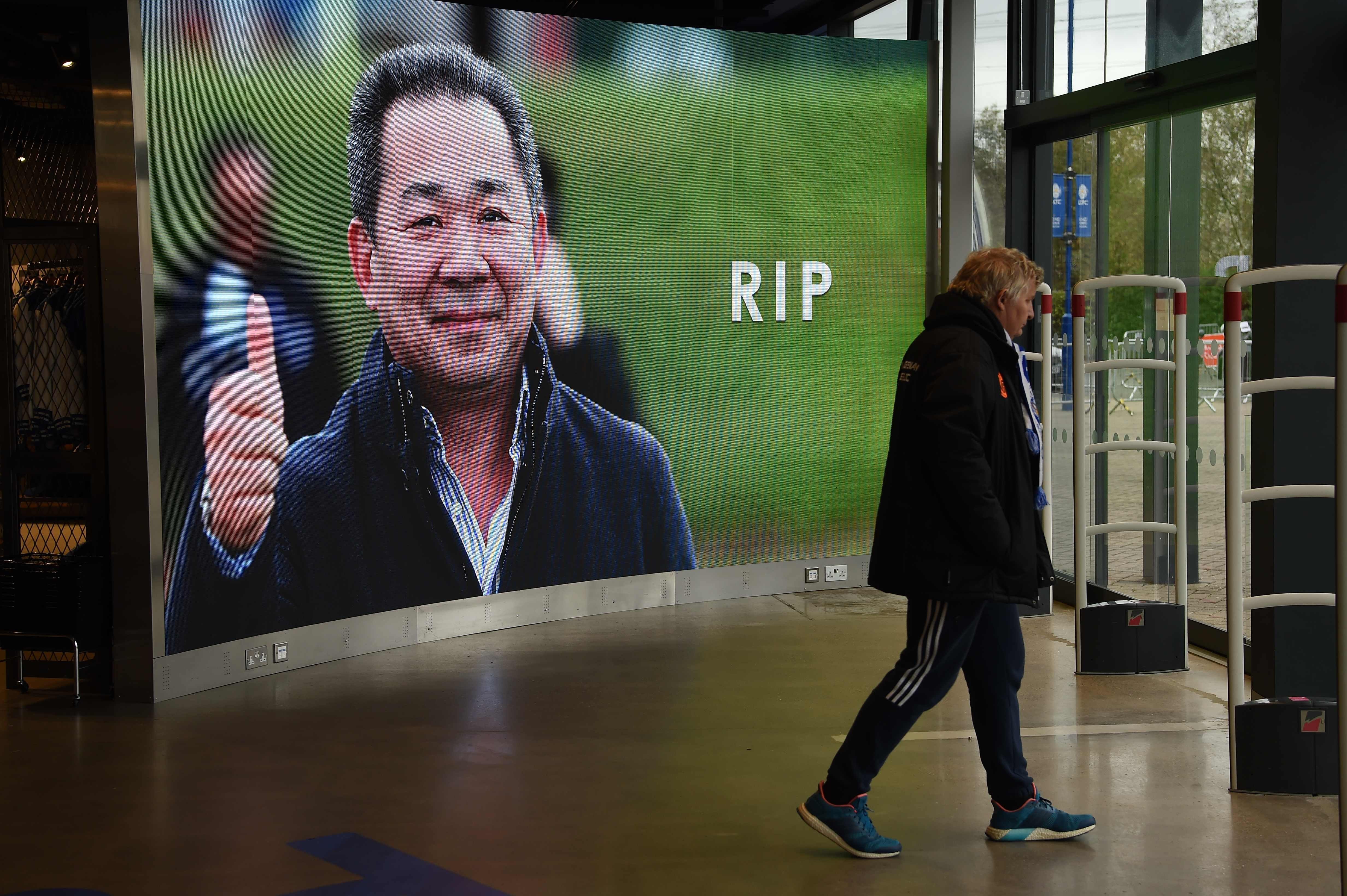 A man leaves the Leicester City fan store in front of a big screen showing a tribute to the club’s Thai chairman Vichai Srivaddhanaprabha, who died in a helicopter crash outside the King Power Stadium. Photo: AFP