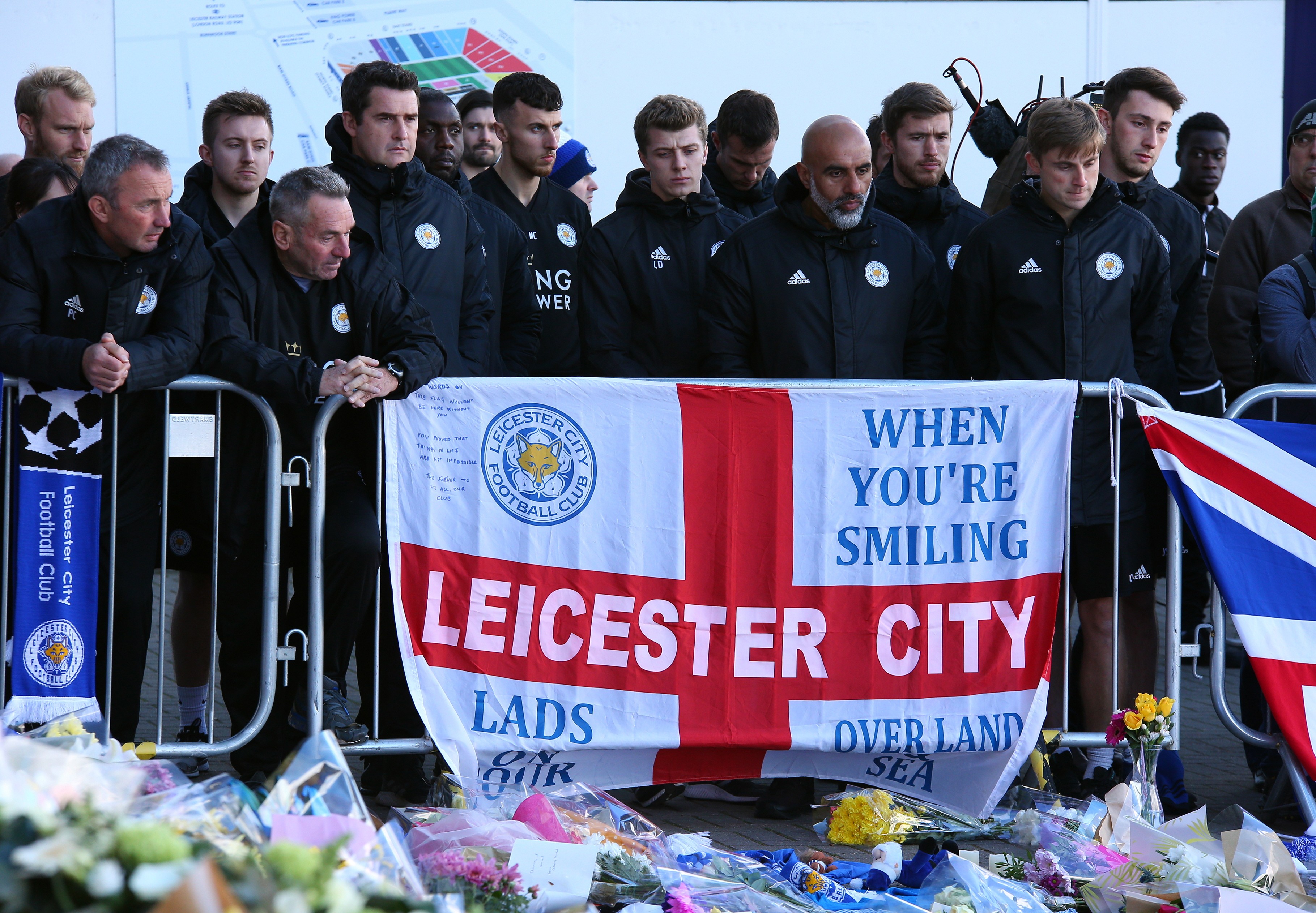 Leicester City players and staff pay their respects outside the King Power Stadium. Photo: EPA