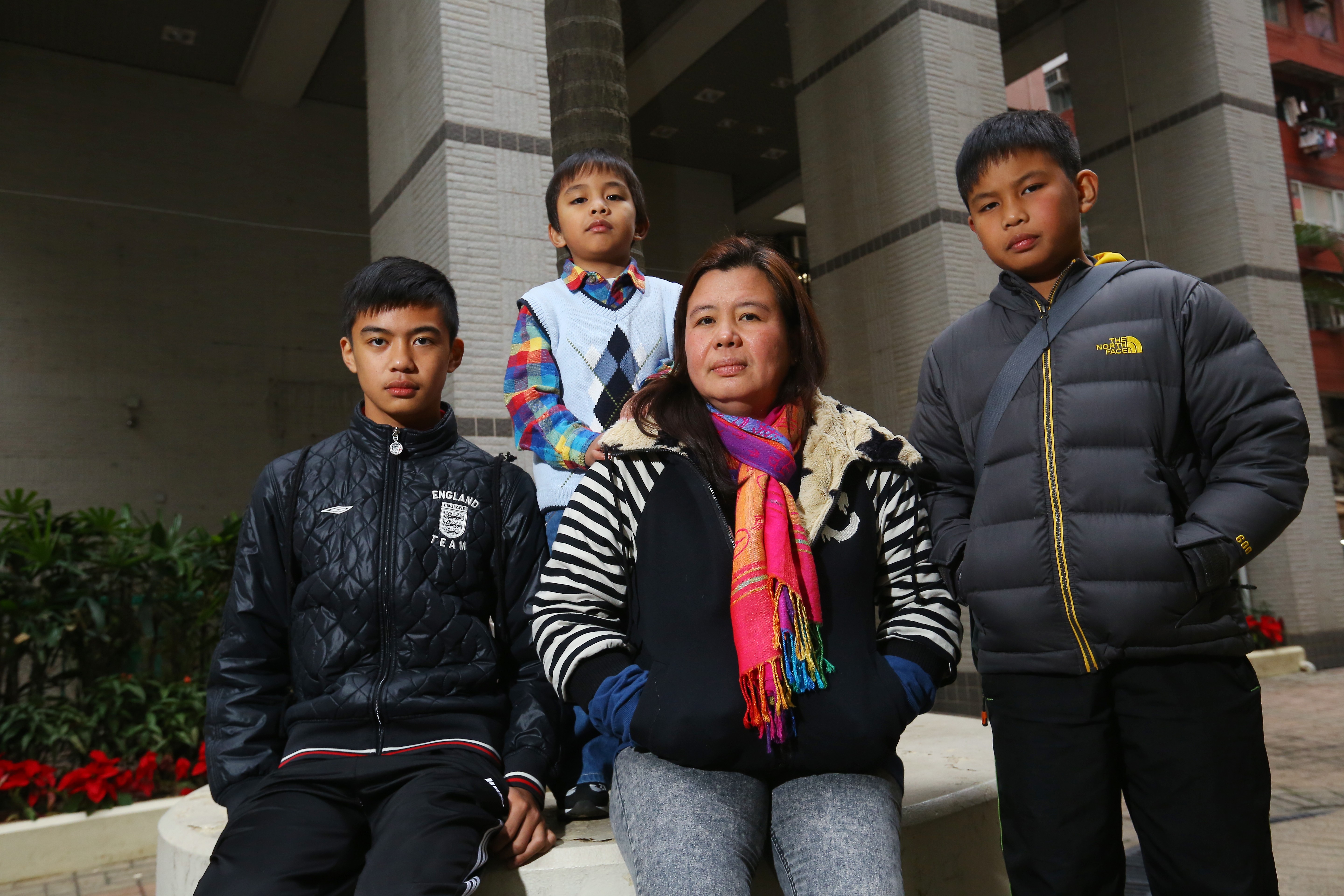 Desiree Rante Luis (centre), who may be separated from her sons (from left) David John, Mark Joelery and Carl Benz. Photo: Edmond So
