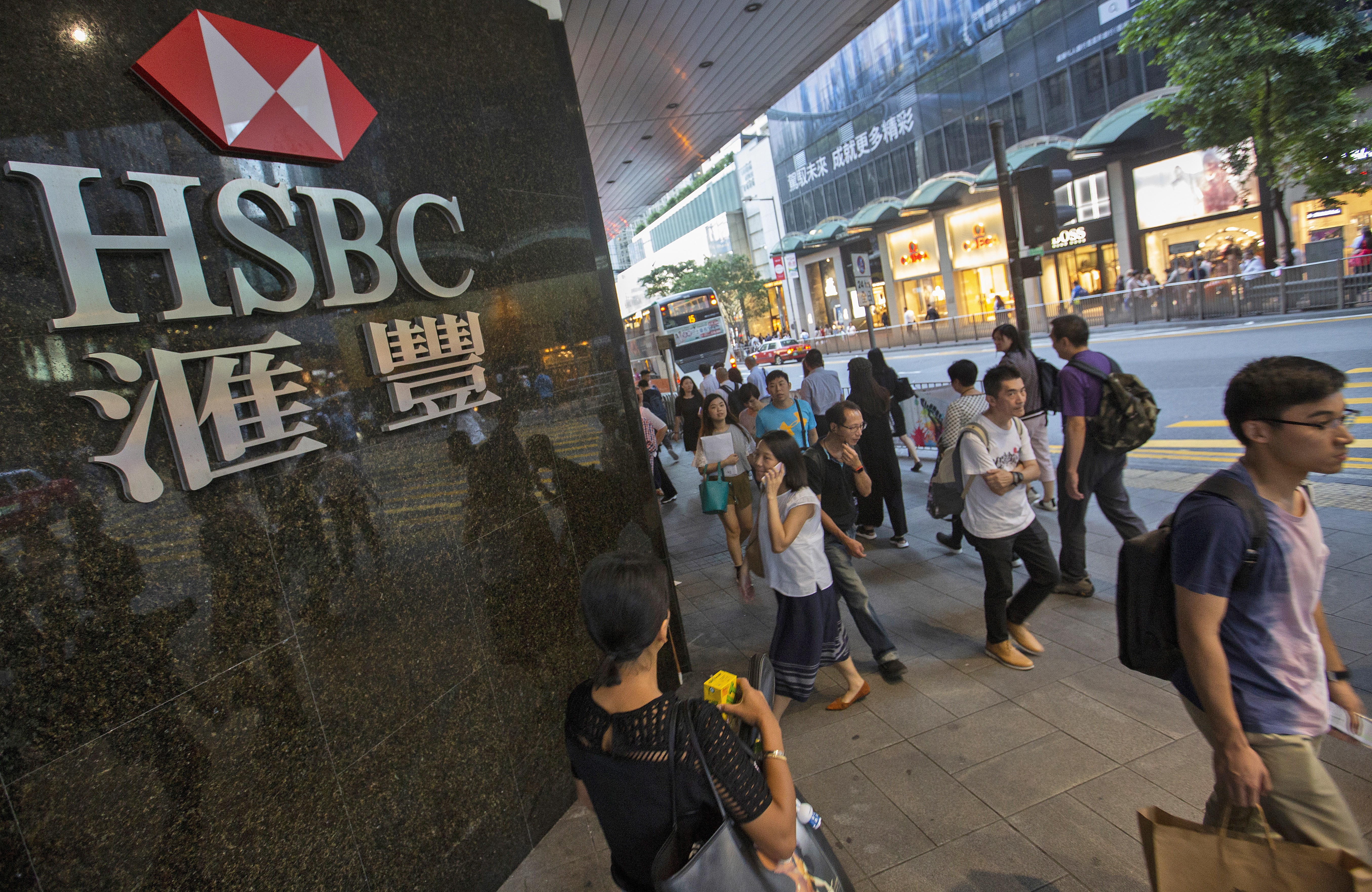 People walk past the HSBC logo in Central District on October 29. HSBC posted strong third-quarter profits, despite a leaked memo, revealed in September, from investment bankers that criticised the company’s “utterly failed” investment banking strategy. Photo: EPA-EFE