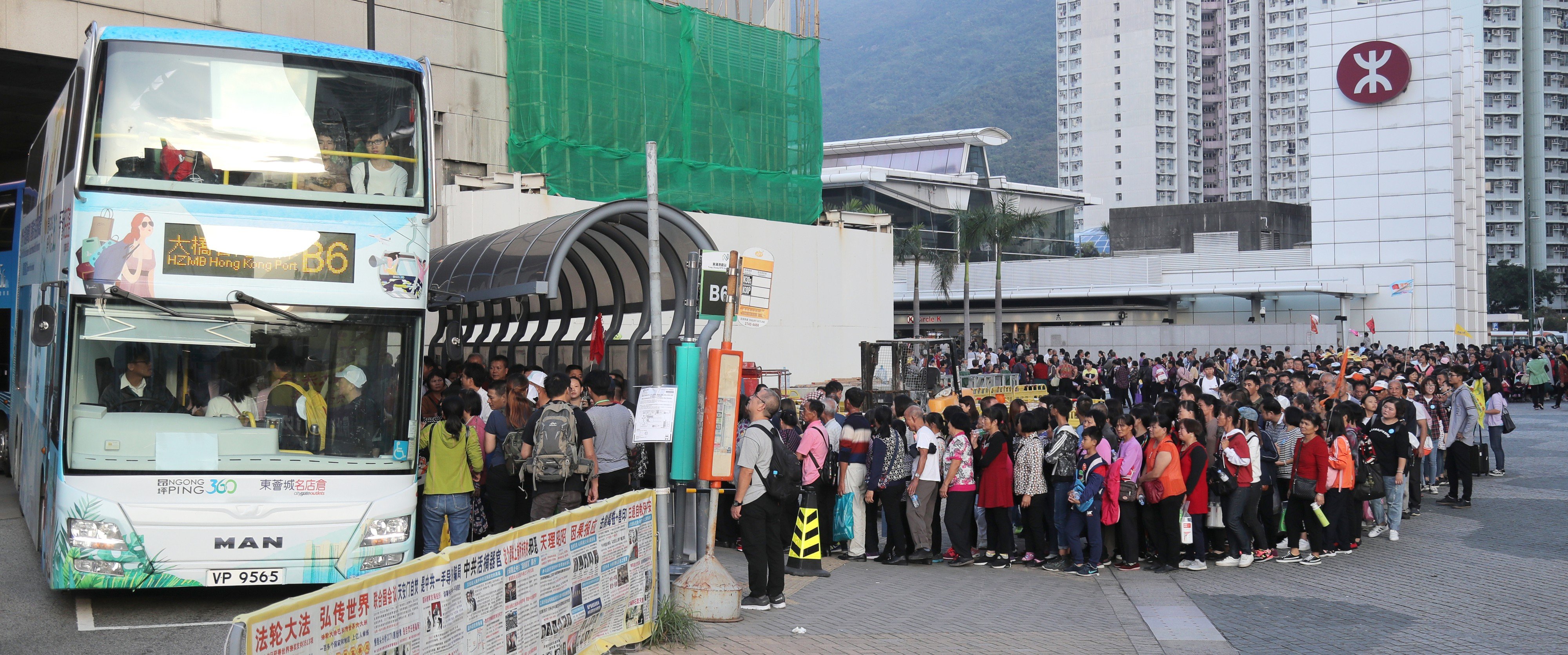 Mainland tourists wait for the bus at Tung Chung MTR station. Photo: SCMP Pictures