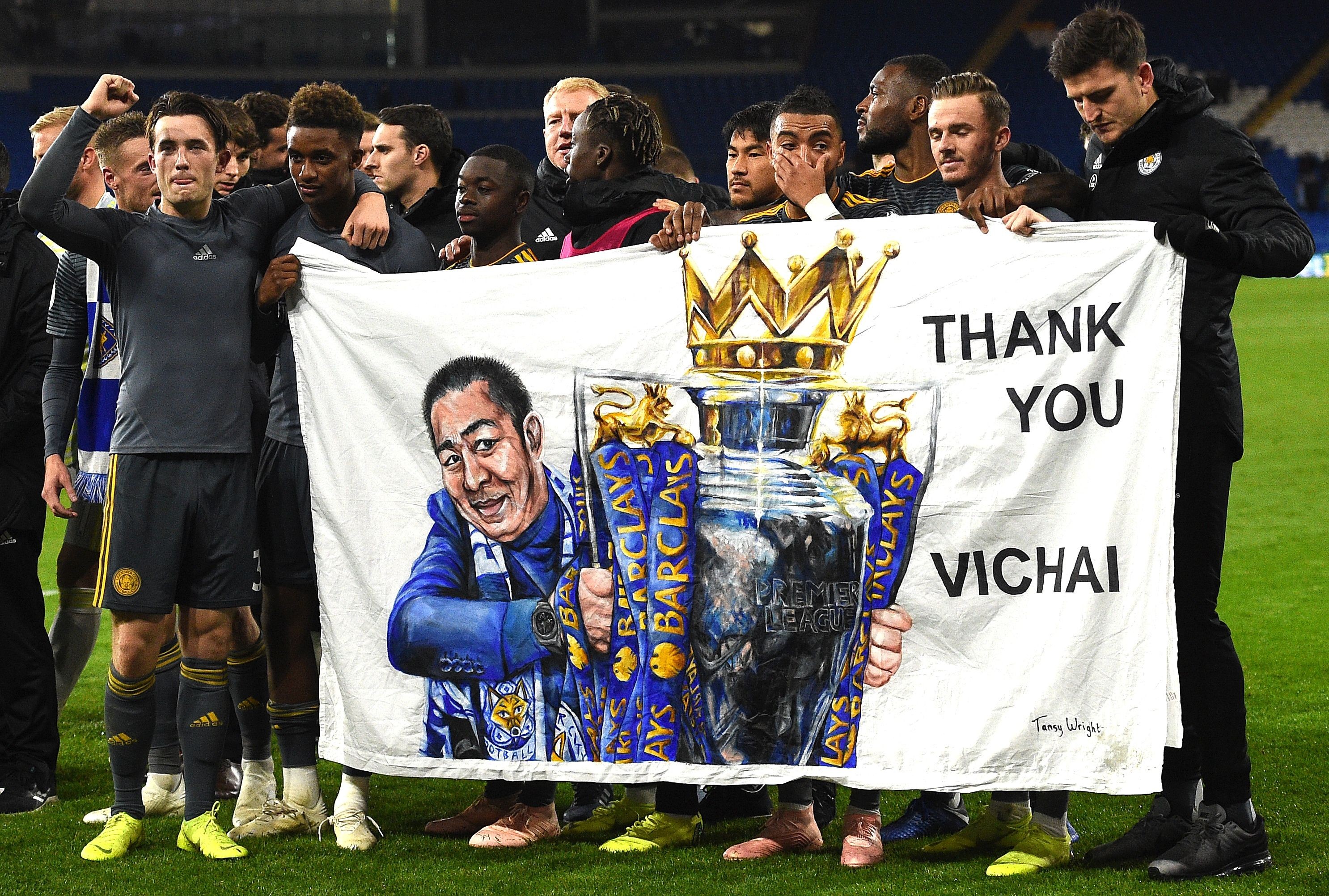 Leicester’s players hold a banner in tribute to Vichai Srivaddhanaprabha. Photo: AFP