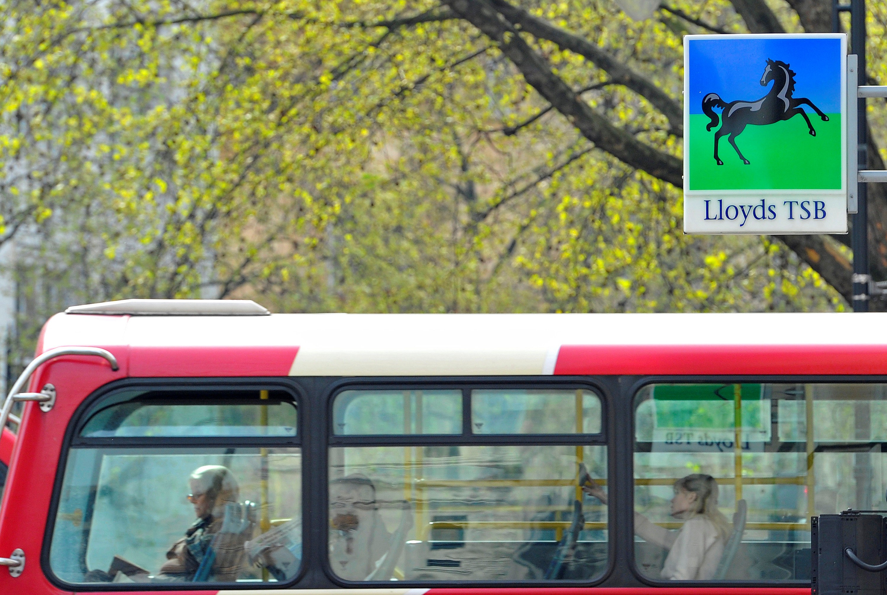 File photo of a London bus passing a branch of Lloyds TSB bank in central London. Photo: Reuters