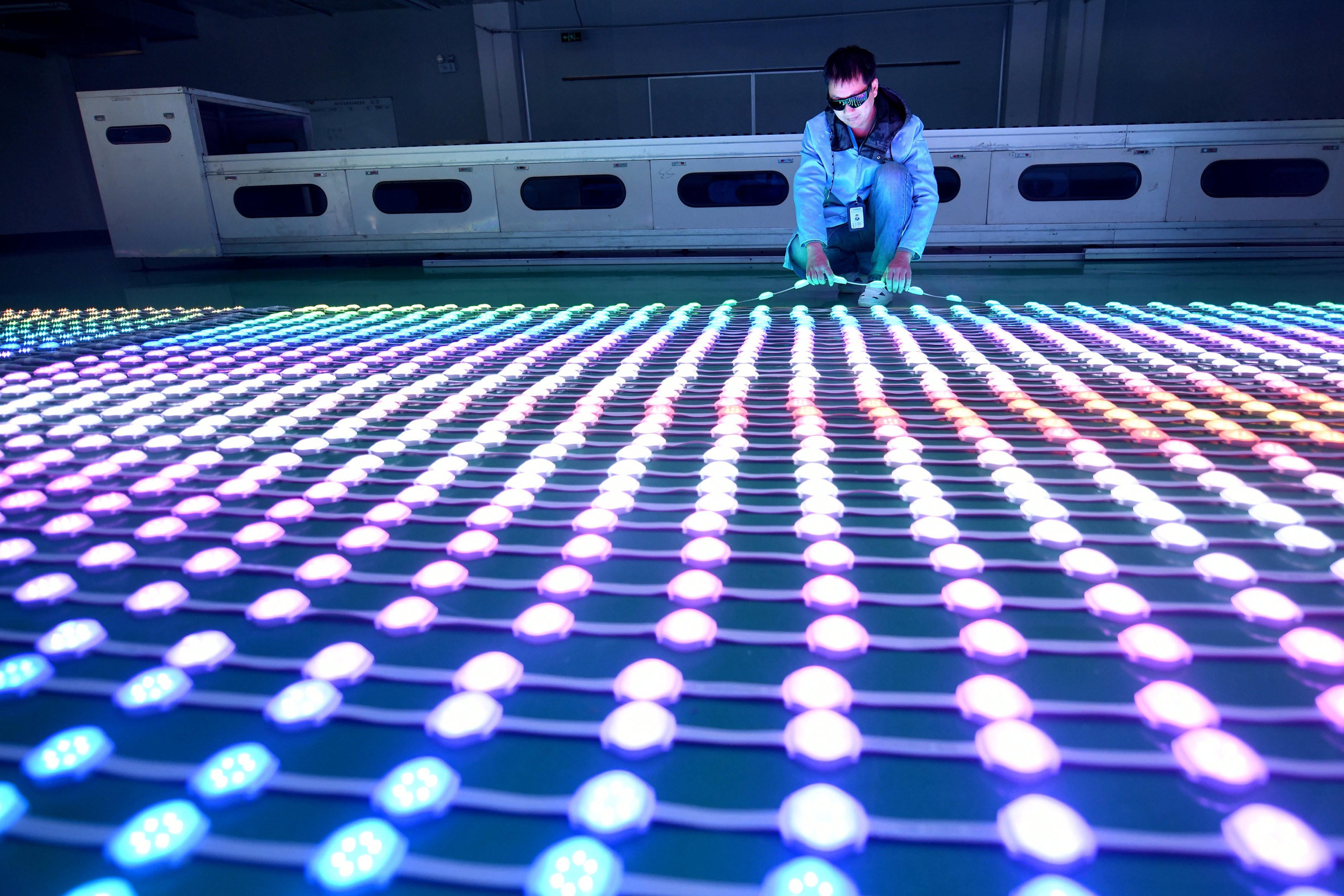 A worker examines LEDs at a manufacturing plant in Haian, Jiangsu province, China. Photo: Reuters