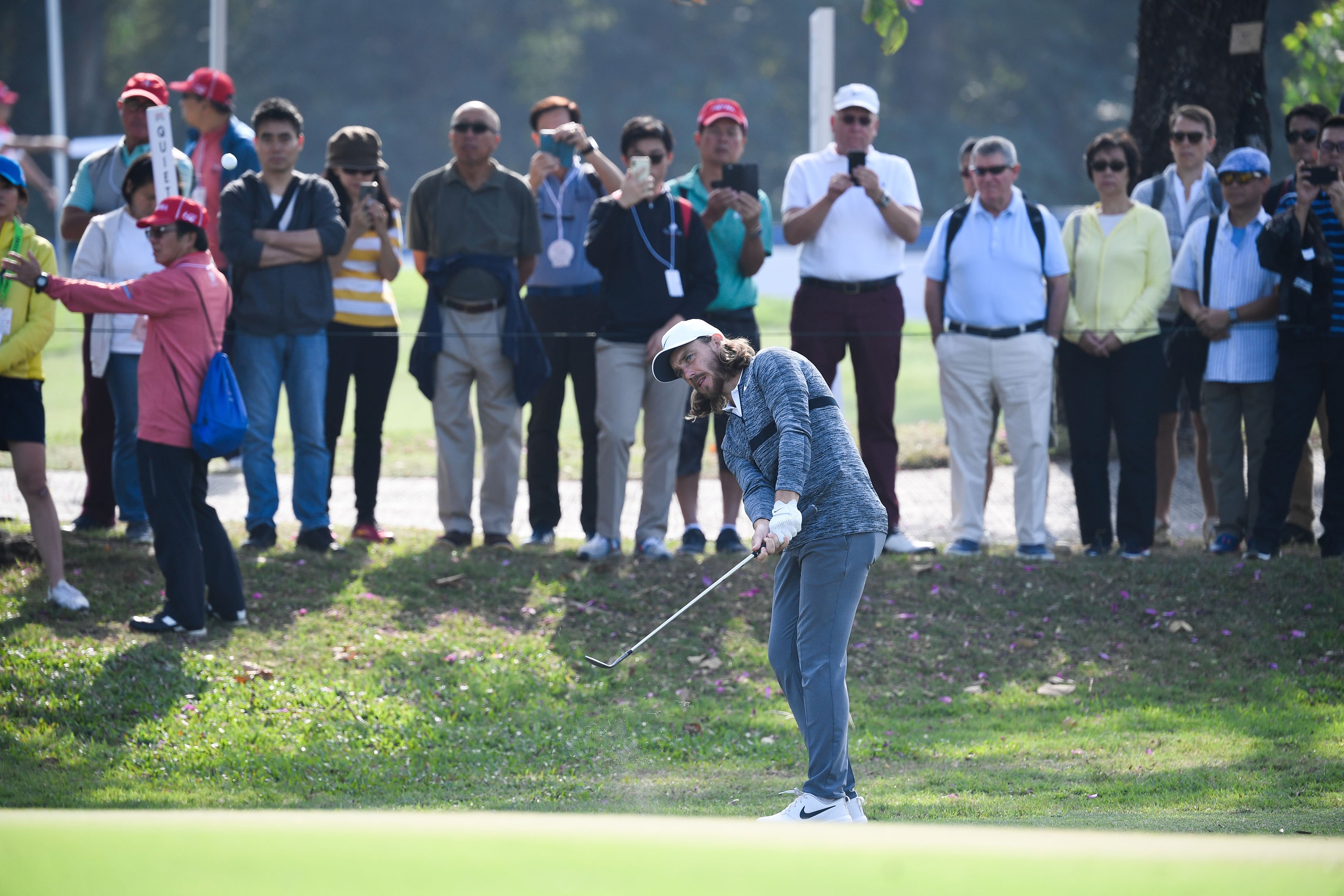 Tommy Fleetwood chips in front of the gallery. Photos: Richard Castka