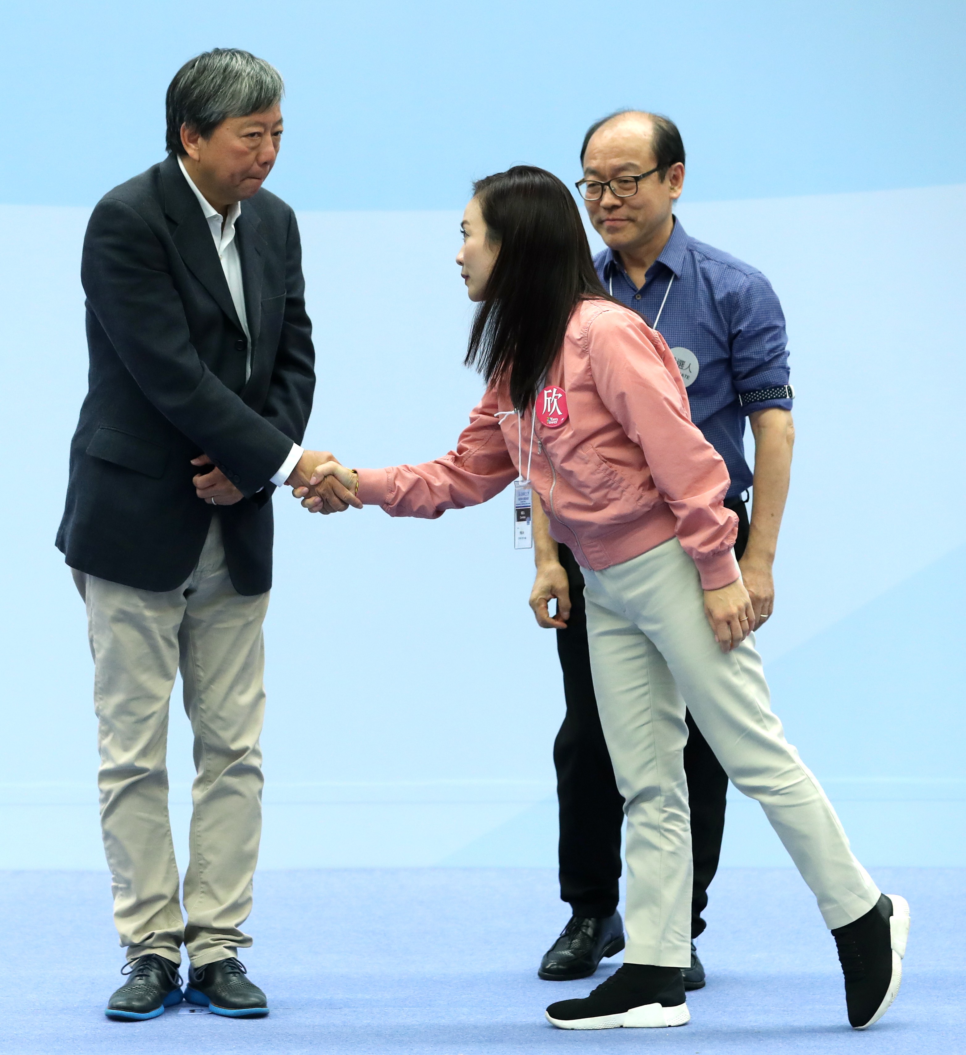 Defeated Lee Cheuk-yan shakes hands with by-election winner Rebecca Chan Hoi-yan as fellow loser Frederick Fung Kin-kee looks on. Photo: Sam Tsang