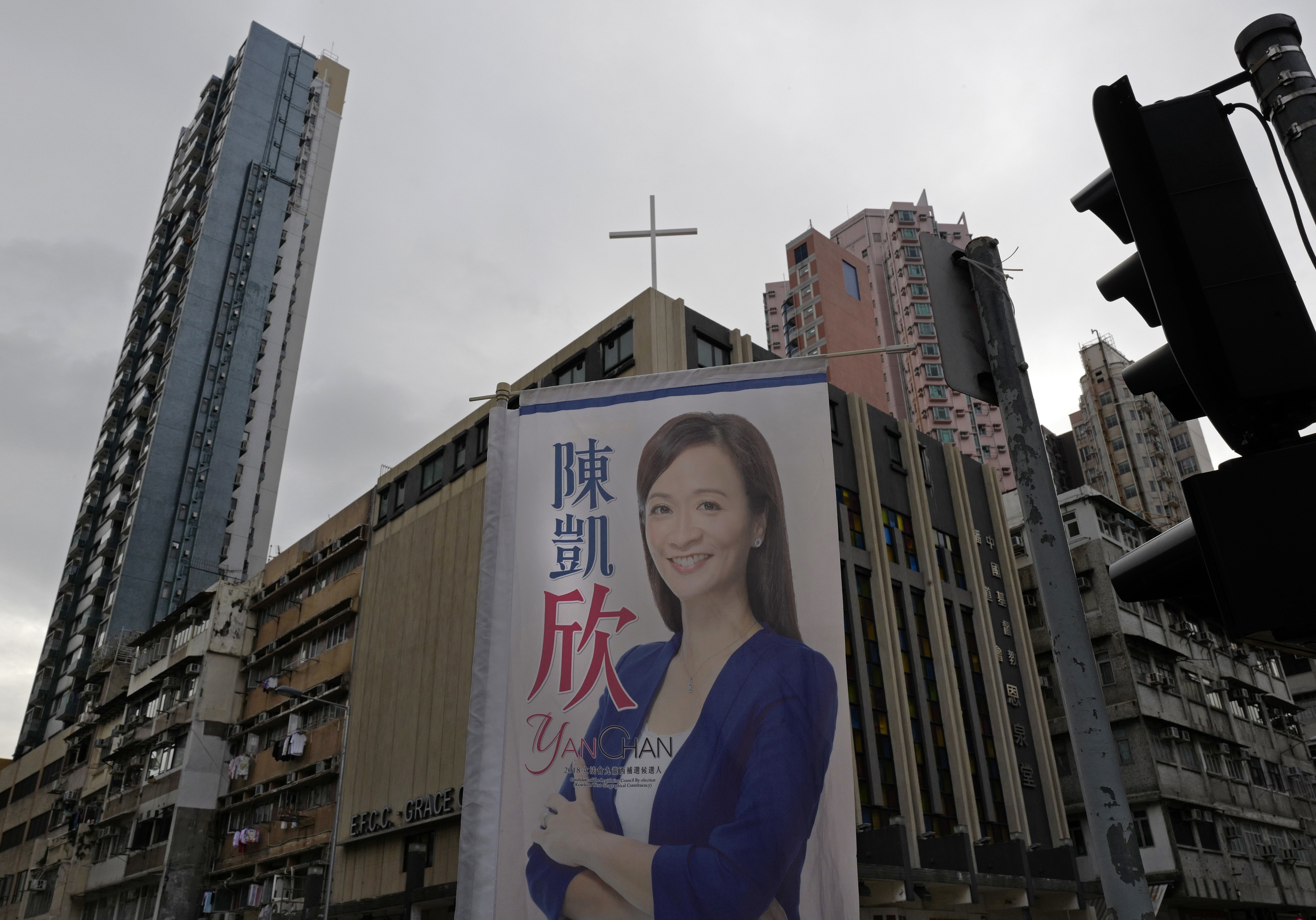 A poster for pro-establishment candidate Chan Hoi-yan hangs on a street corner after she won the West Kowloon by-election in Hong Kong. Photo: AP