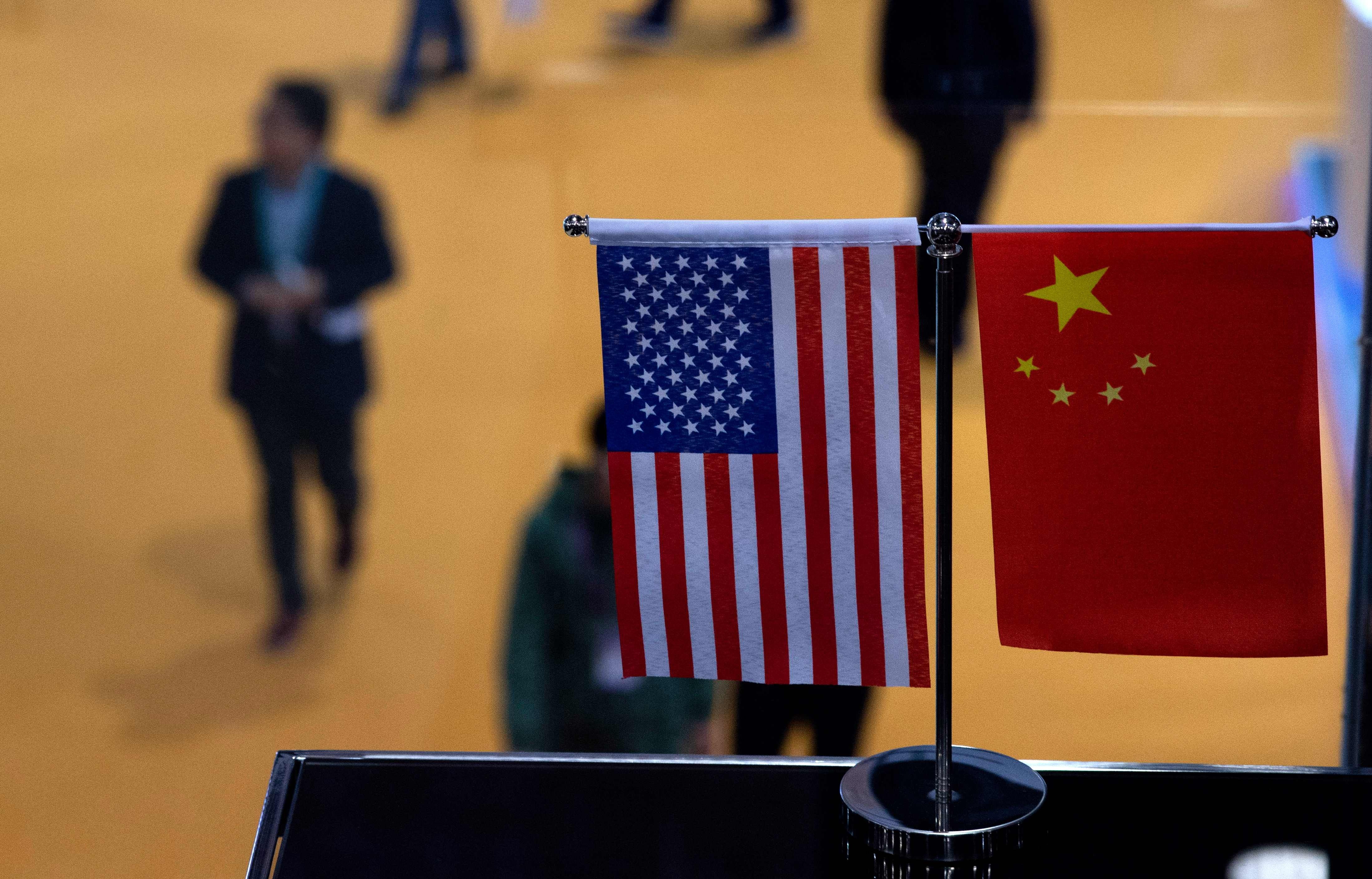 US and Chinese flags in Shanghai. Photo: AFP
